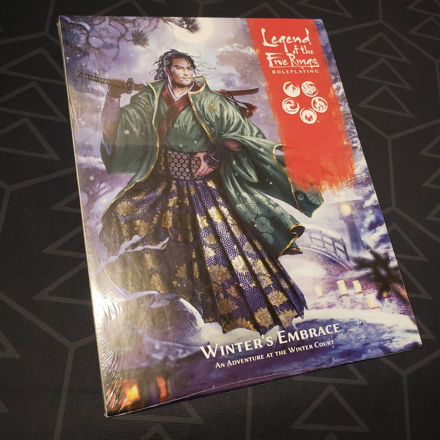 Image shows the front cover of the Winter's Embrace book for the roleplaying game Legend of the Five Rings: Fifth Edition