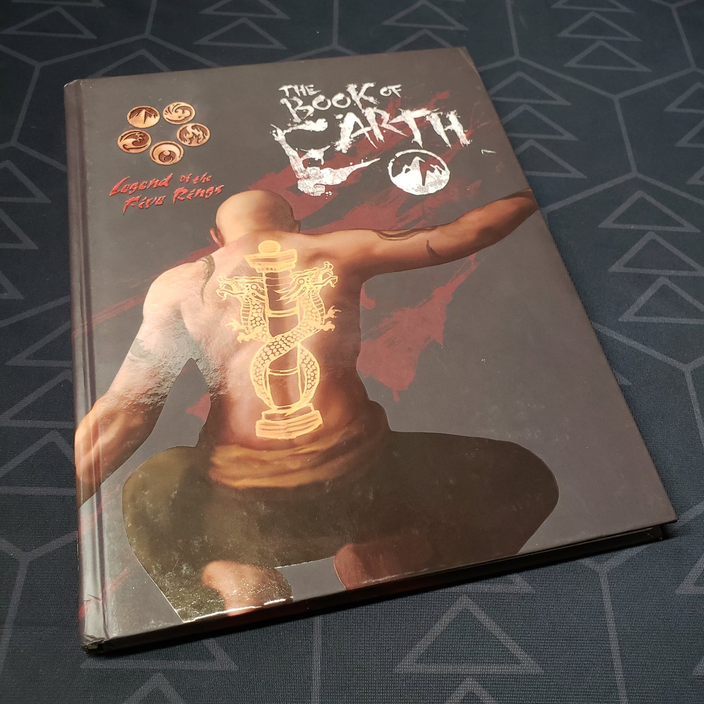 Image shows the front cover of the Book of Earth for the roleplaying game Legend of the Five Rings: Fourth Edition