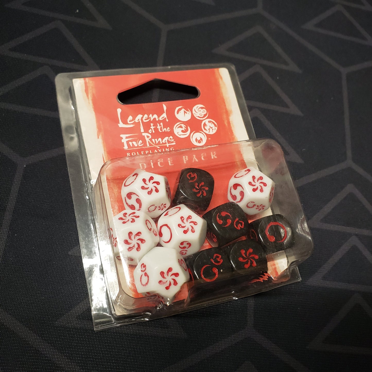 Image shows the front of the packaging of the Dice Pack for the roleplaying game Legend of the Five Rings: Fifth Edition
