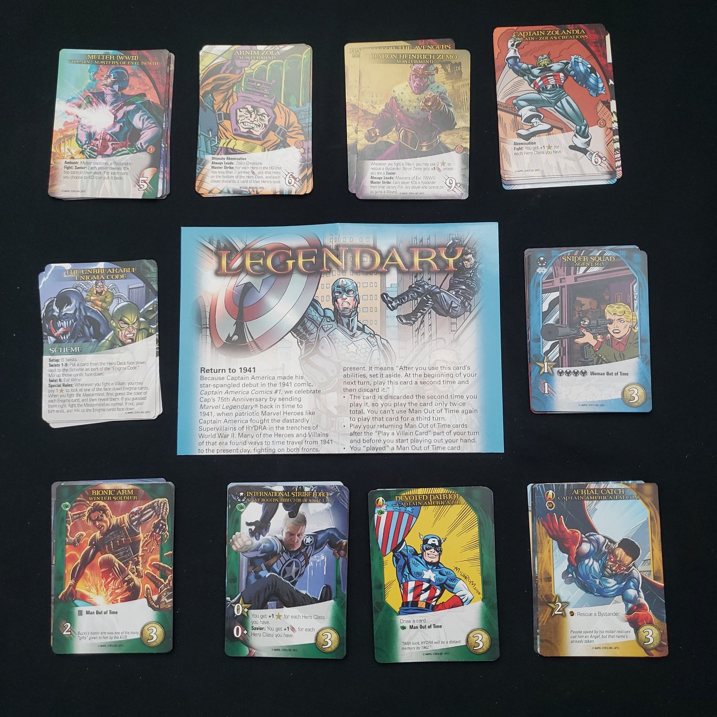 Image shows the instructions & cards arranged in stacks by card type for the Captain America 75th Anniversary expansion for the board game Legendary Marvel