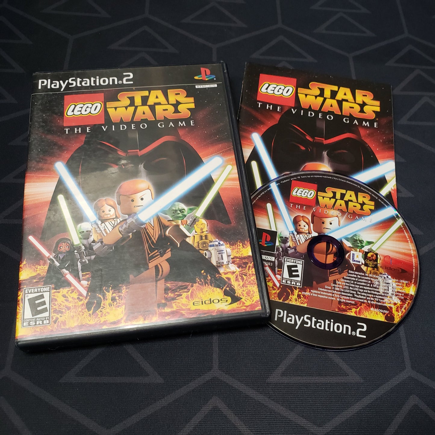 Image shows the case, manual and disc for the video game LEGO Star Wars: The Video Game for Playstation 2