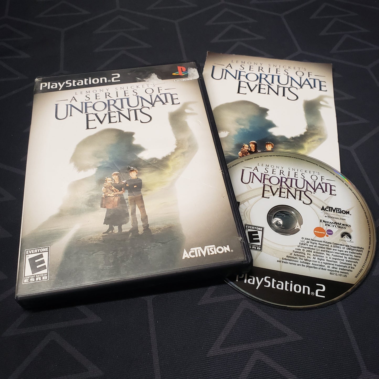 Image shows the case, manual and disc for the video game Lemony Snicket's A Series of Unfortunate Events for Playstation 2