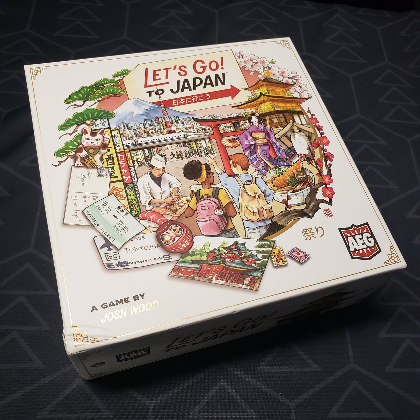 Image shows the front cover of the box for the Let's Go! To Japan board game