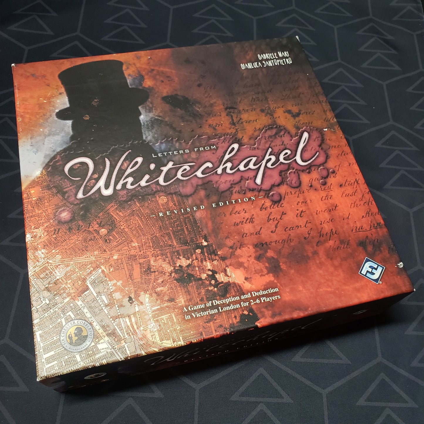 Image shows the front cover of the box of the Letters From Whitechapel board game