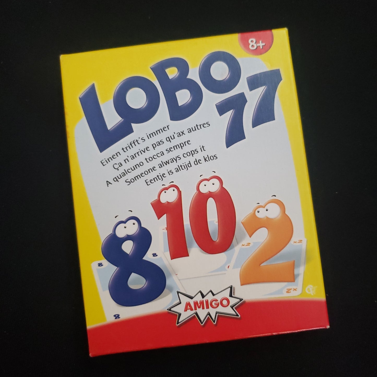 Image shows the front cover of the box of the Lobo 77 card game