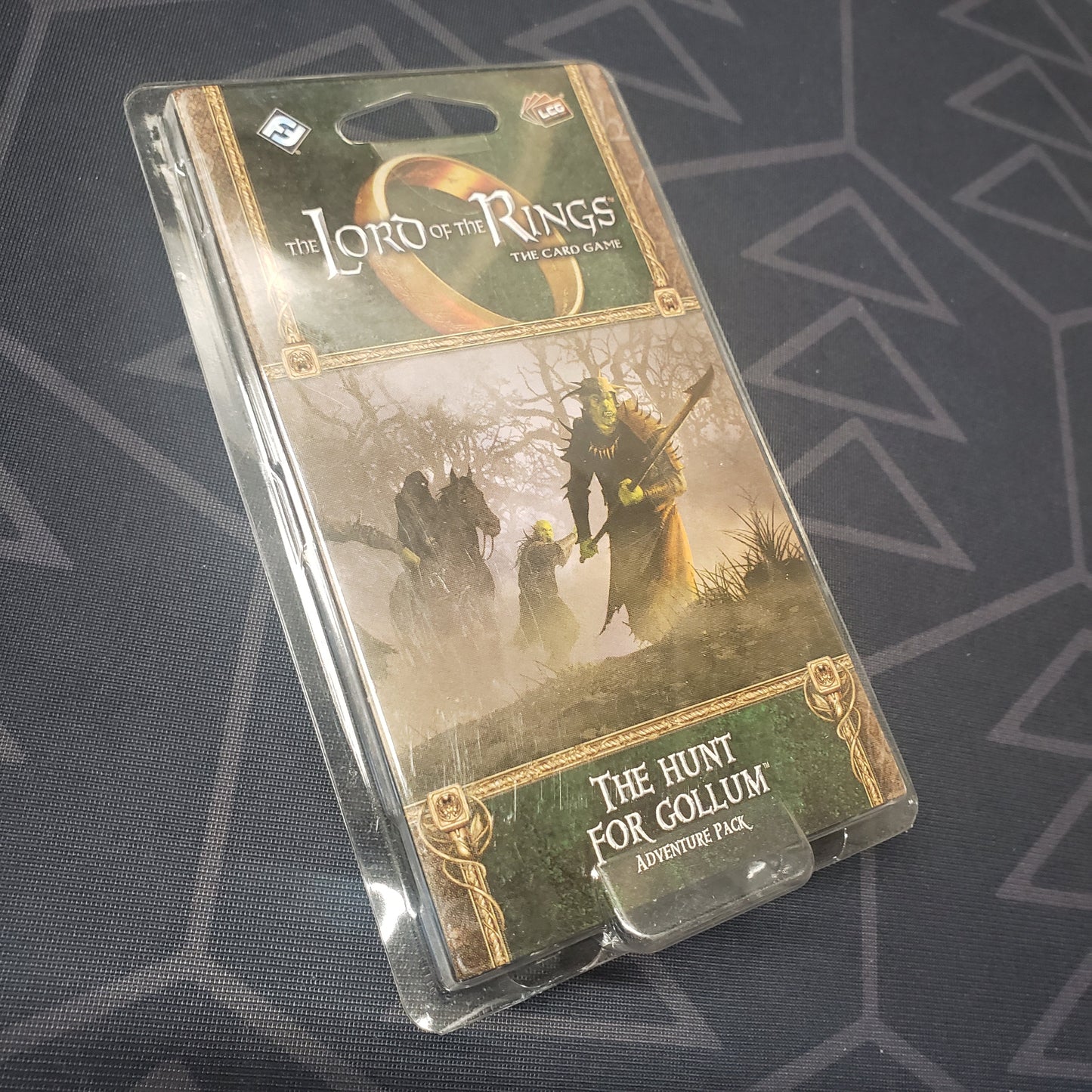 Image shows the front of the package for the Hunt for Gollum Adventure Pack for the Lord of the Rings card game