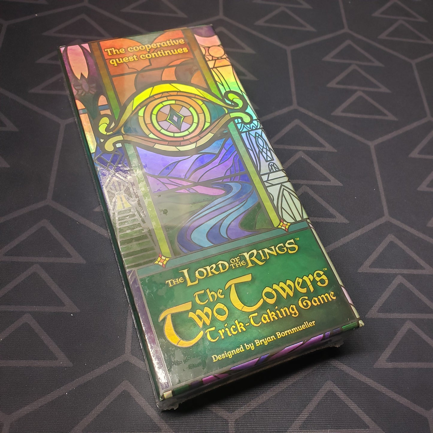 Image shows the front cover of the box for the card game Lord of the Rings: The Two Towers Trick-Taking Game