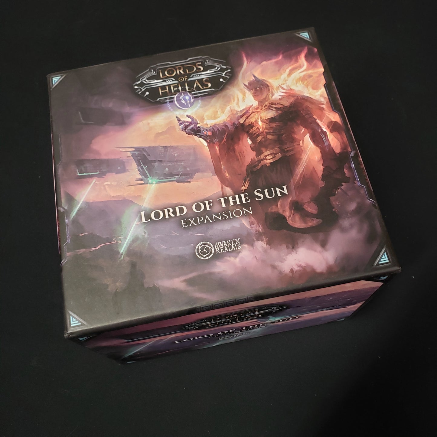 Image shows the front cover of the box of the Lord of the Sun expansion for the board game Lords of Hellas