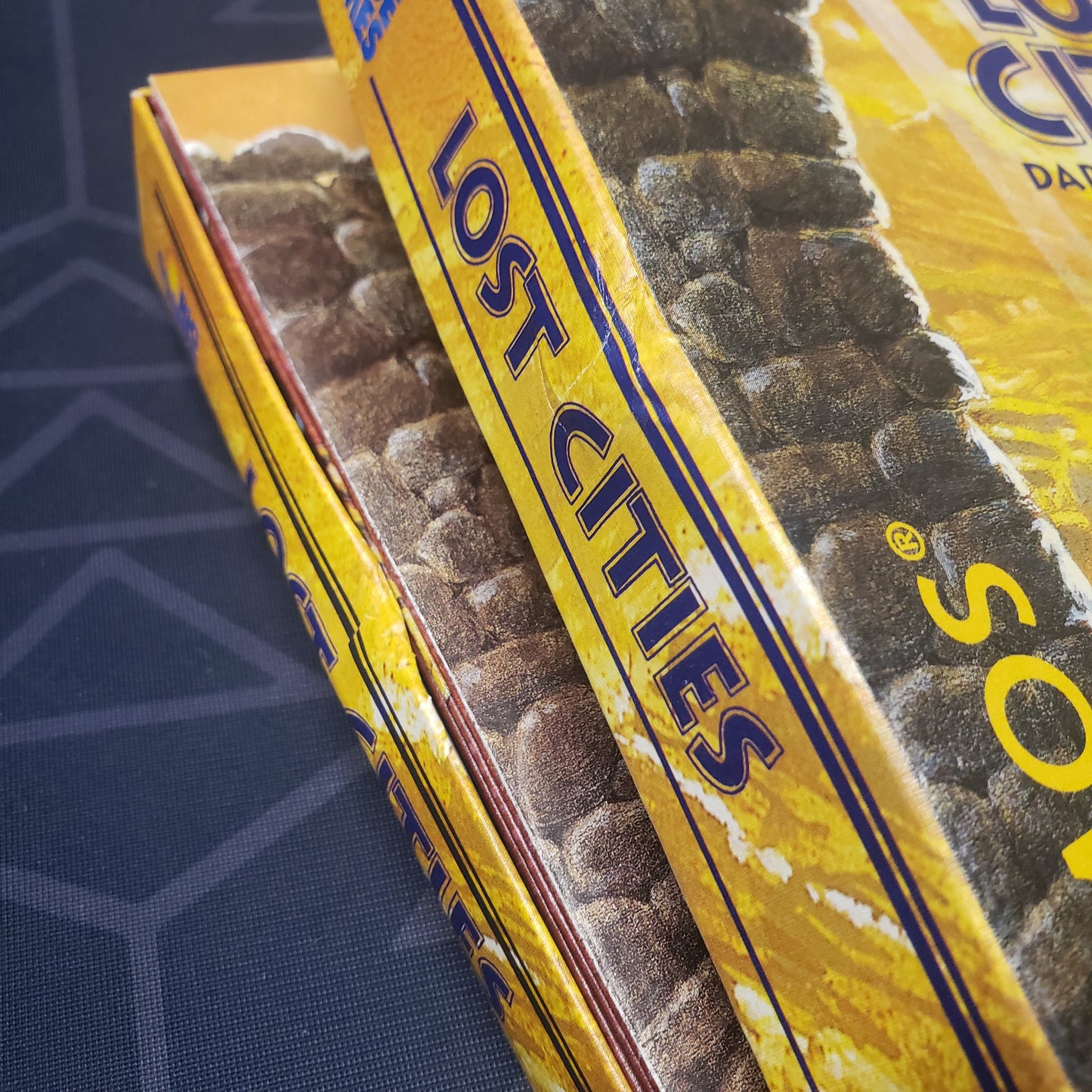 Image shows a spot of damage on the box of the Lost Cities card game