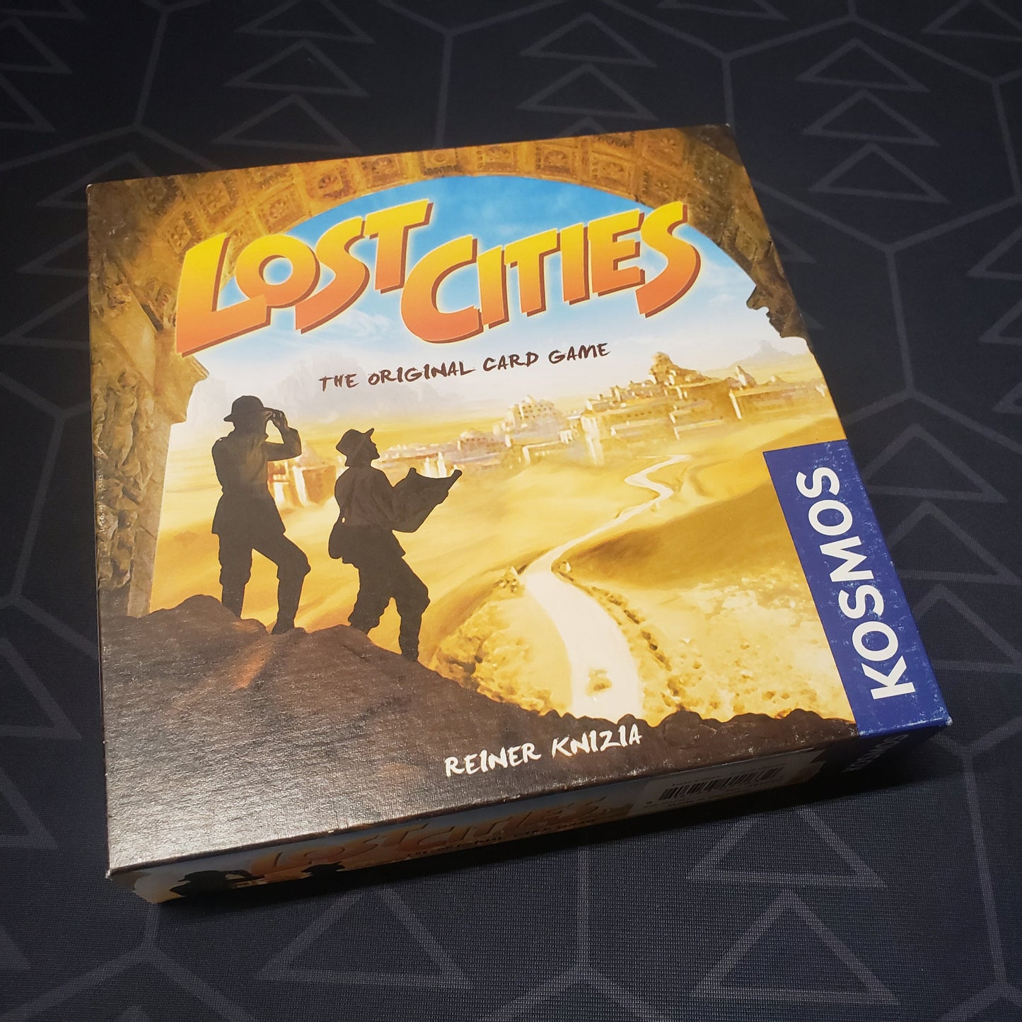 Image shows the front cover of the box of the Lost Cities card game