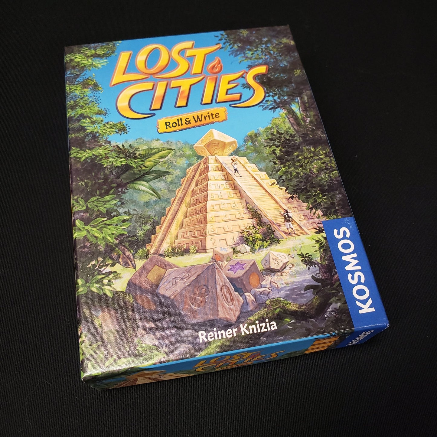 Image shows the front cover of the box of the board game Lost Cities: Roll & Write