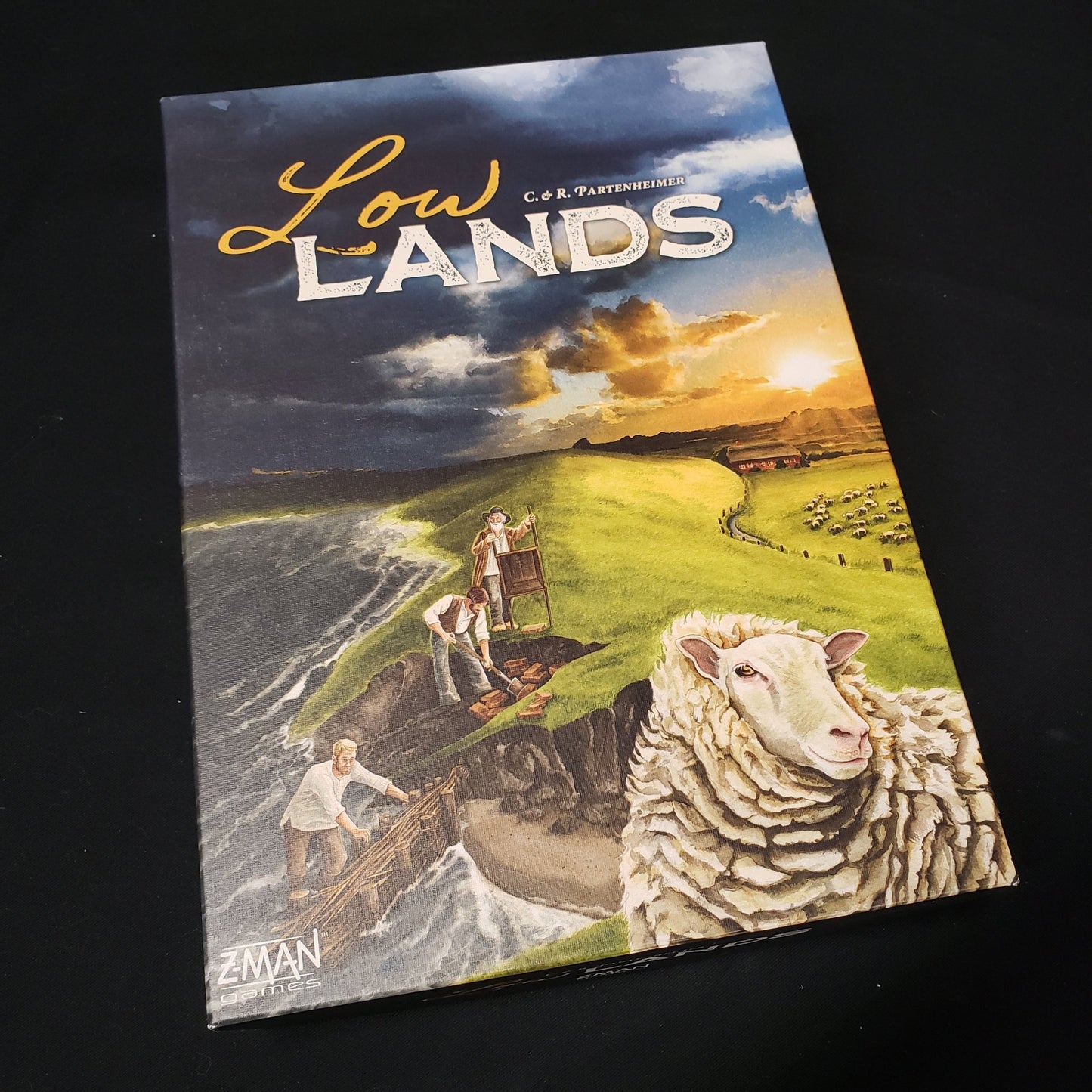 Image shows the front cover of the box of the Lowlands board game