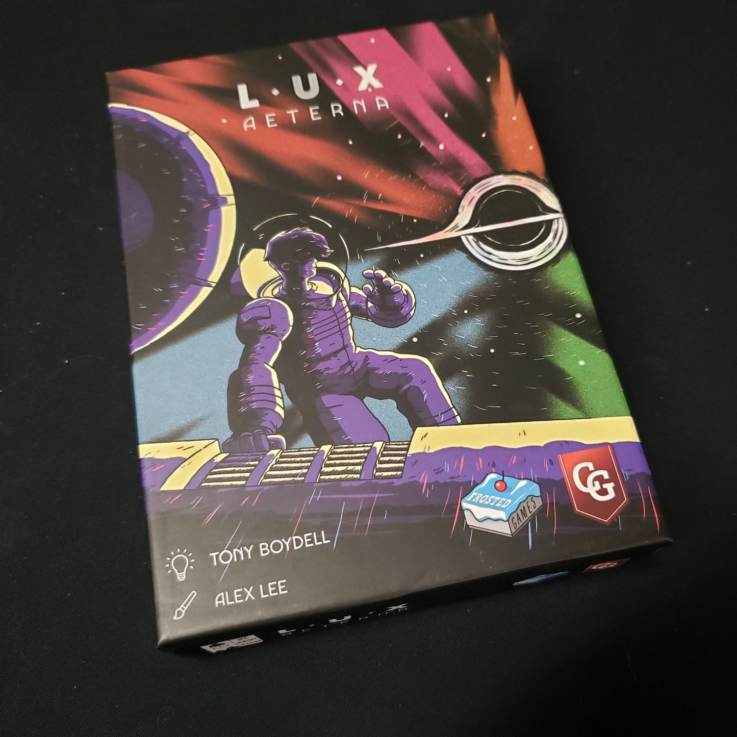 Image shows the front cover of the box of the Lux Aeterna card game