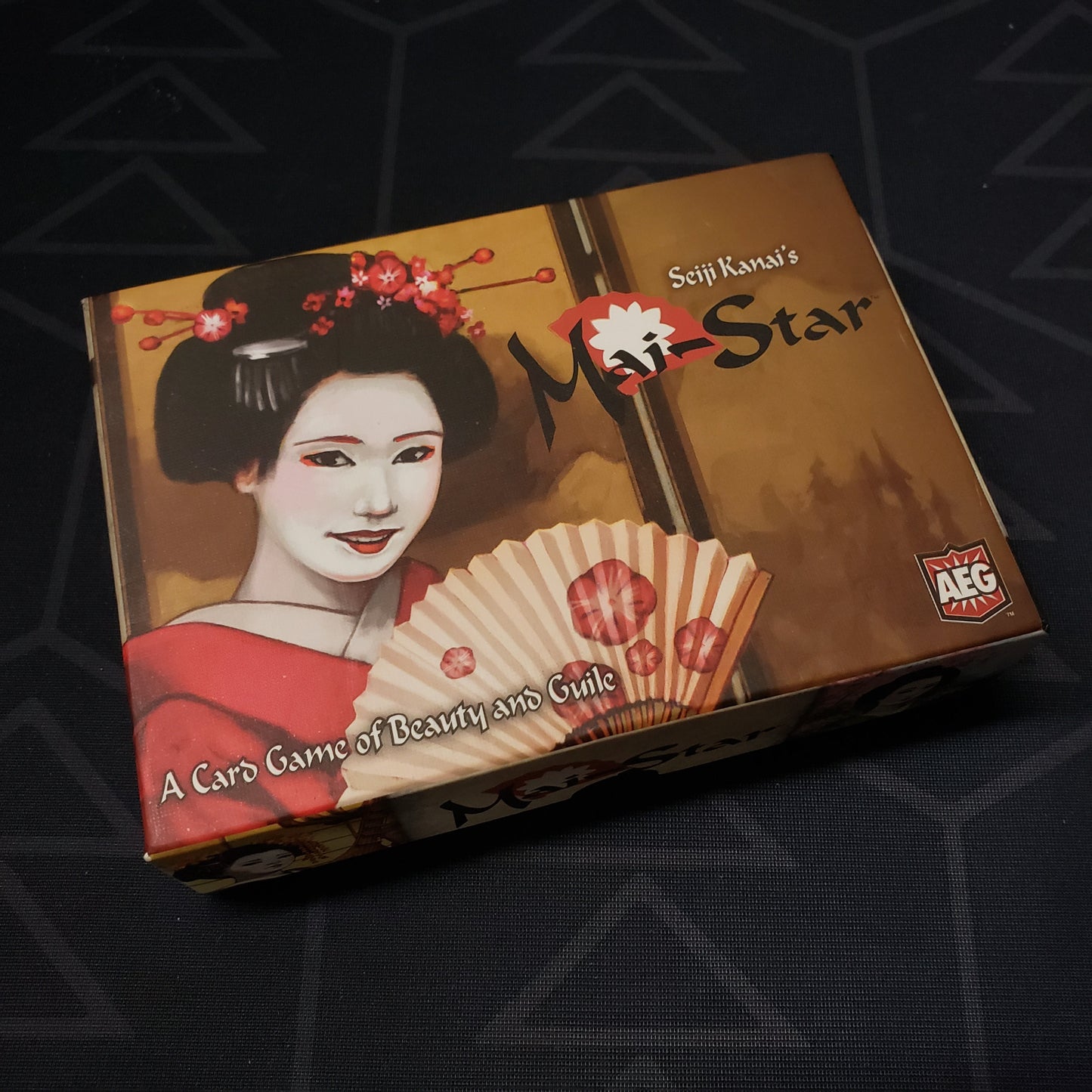 Image shows the front cover of the box for the Mai-Star card game