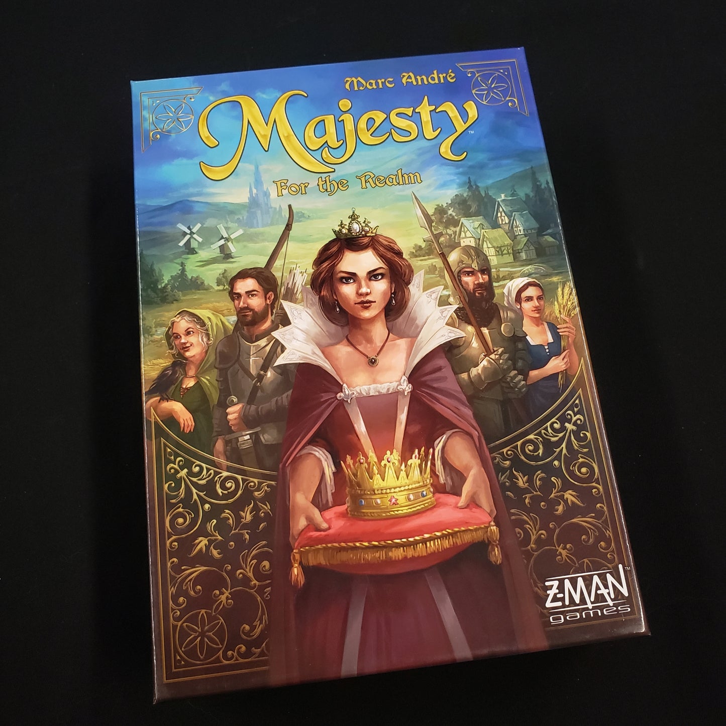 Image shows the front cover of the box of the board game Majesty: For the Realm