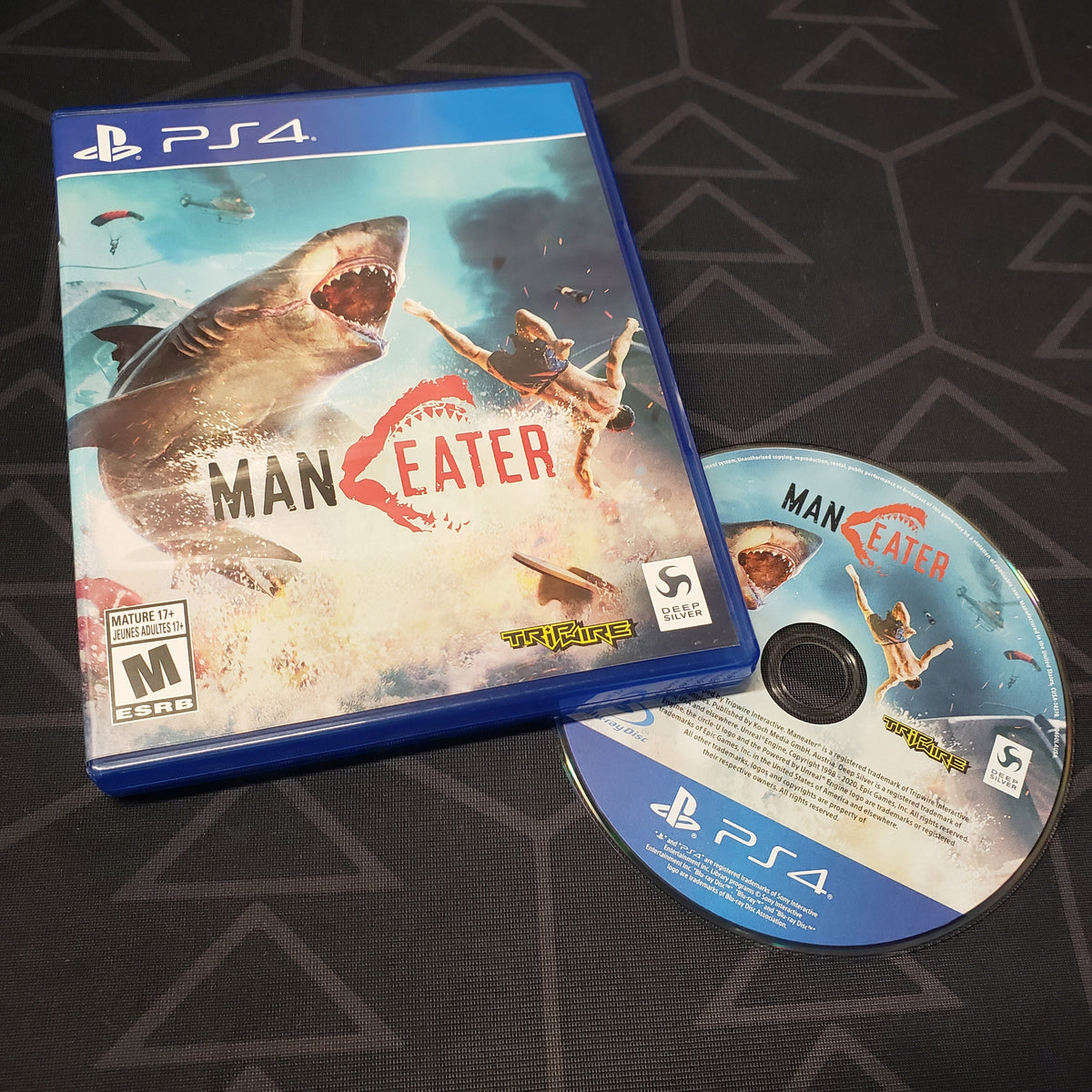 Image shows the case and disc for the video game Maneater for Playstation 4