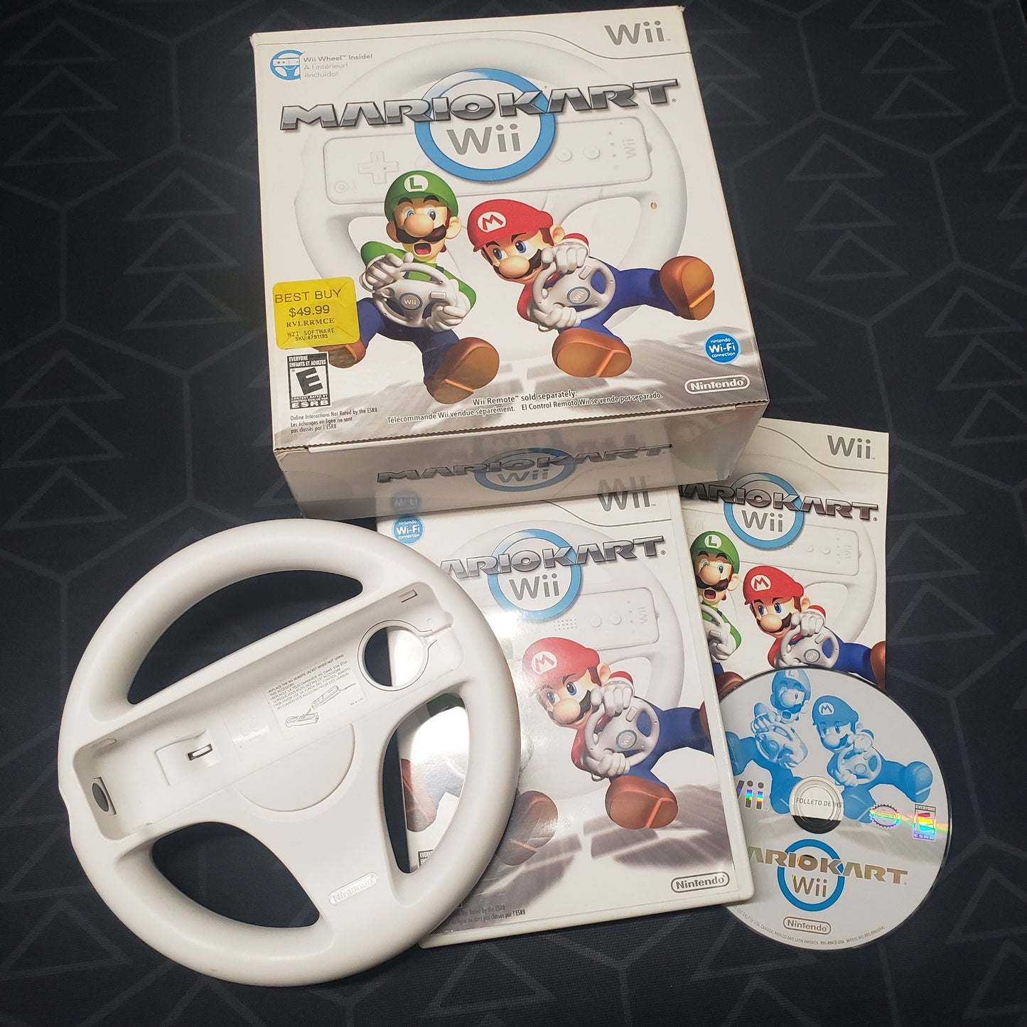 Image shows the case, manual, outer box, wheel accessory and disc for the Wheel Bundle for the video game Mario Kart for Nintendo Wii
