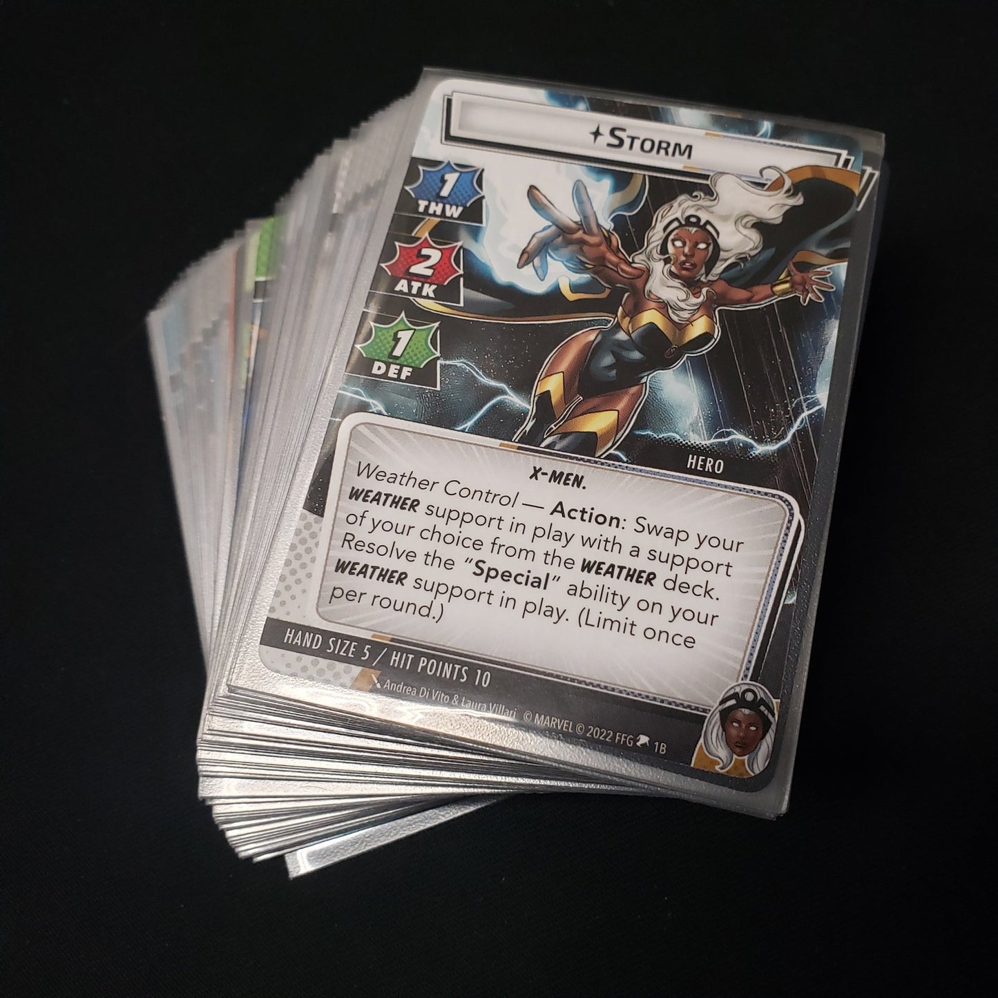 Image shows the cards fanned-out in a stack for the Storm Hero Pack from the Marvel Champions card game