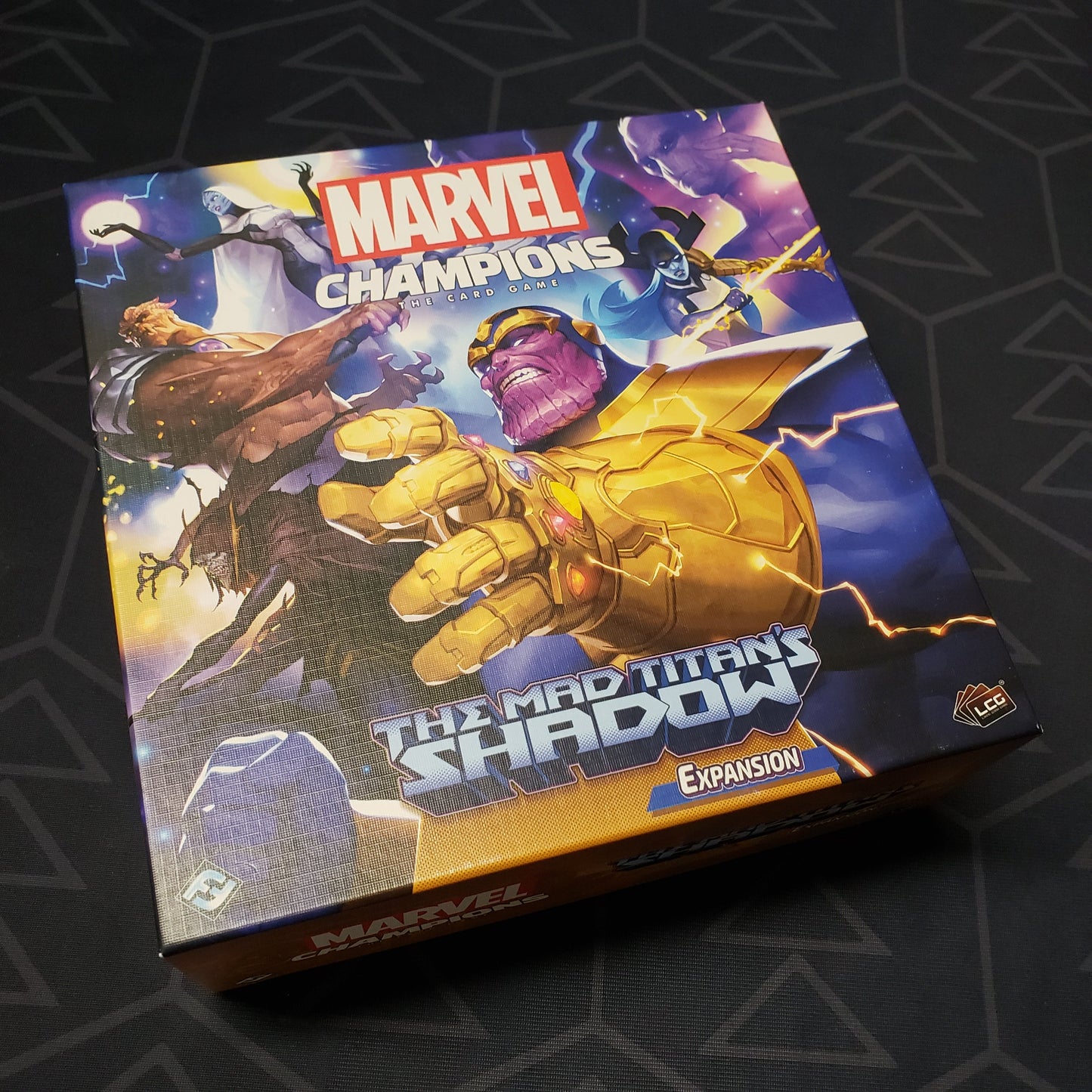 Image shows the front cover of the box of the Mad Titan's Shadow expansion for the Marvel Champions card game