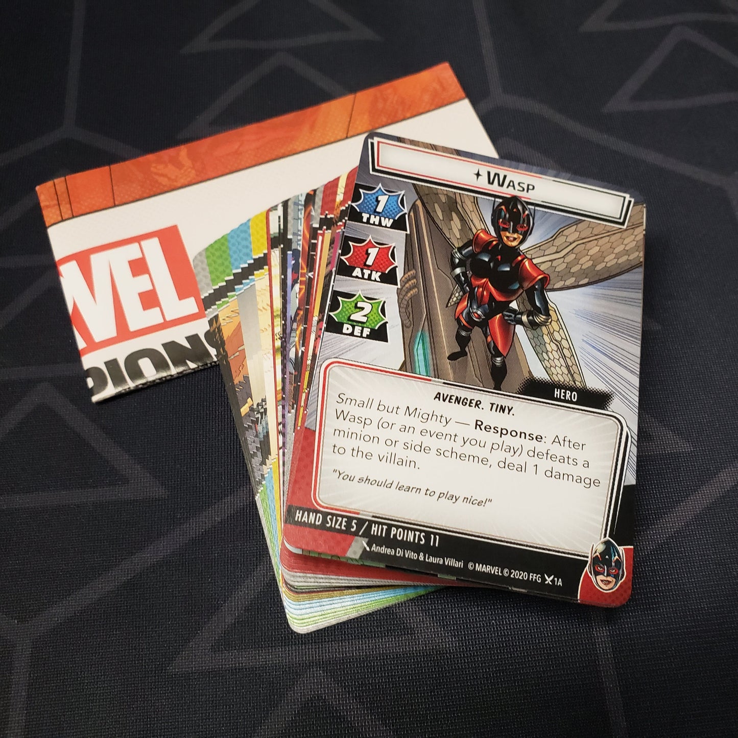 Image shows the instructions & cards fanned-out in a stack for the Wasp Hero Pack from the Marvel Champions card game