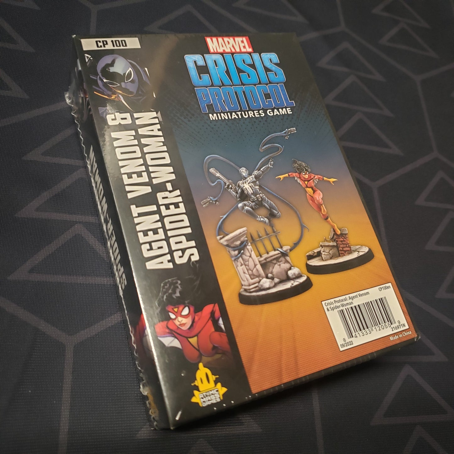 Image shows the front cover of the box of the Agent Venom & Spider-Woman pack for the miniatures game Marvel Crisis Protocol