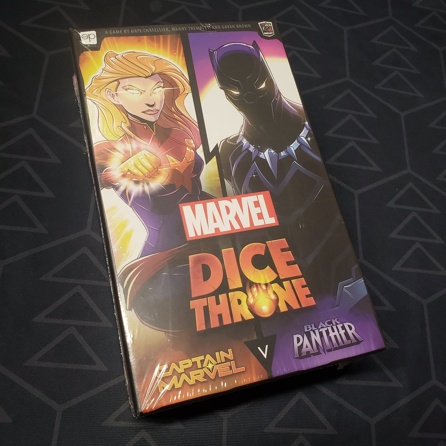 Image shows the front cover of the box for the Marvel Dice Throne: Captain Marvel v. Black Panther board game