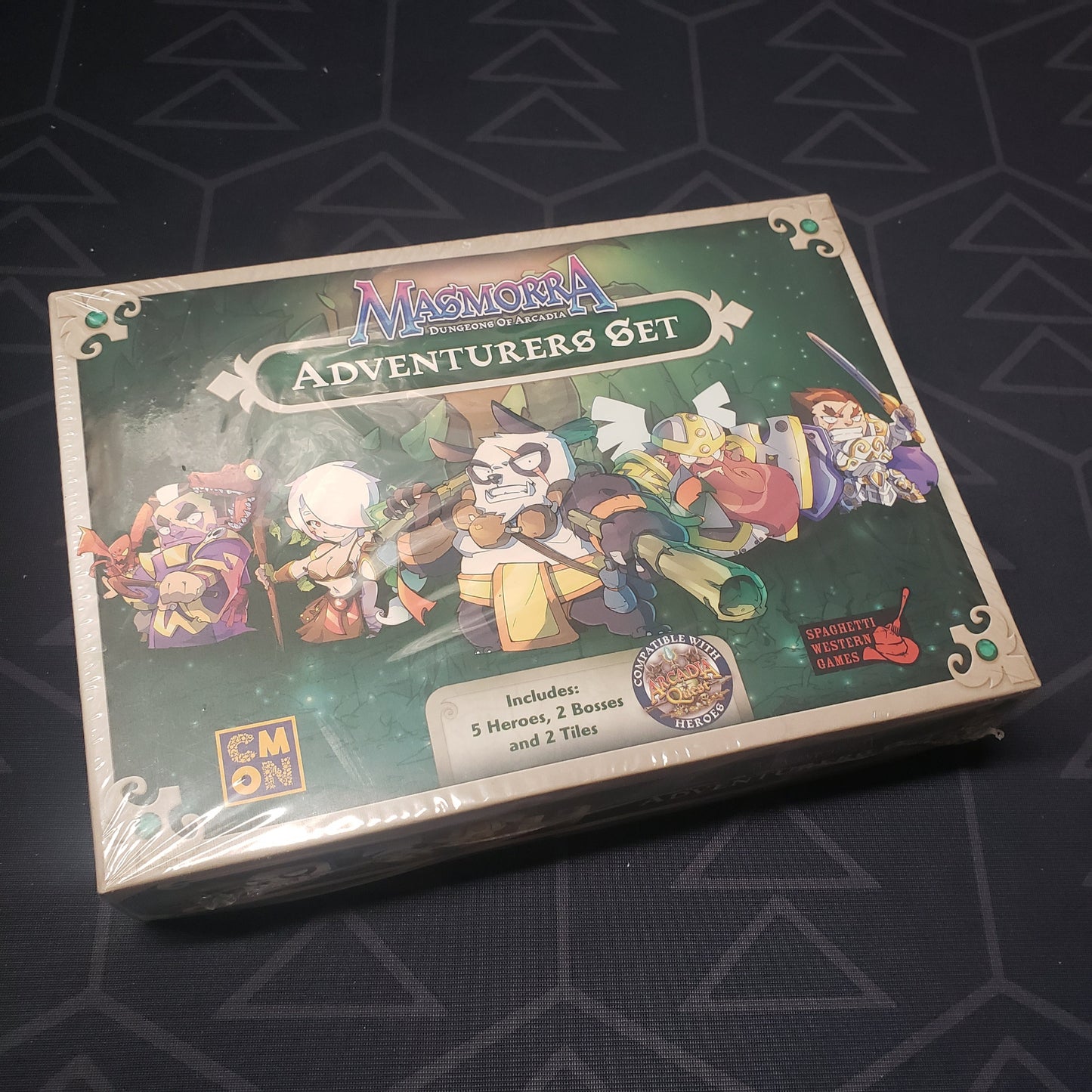 Image shows the front cover of the box of the Adventurers Set expansion for the board game Masmorra: Dungeons of Arcadia