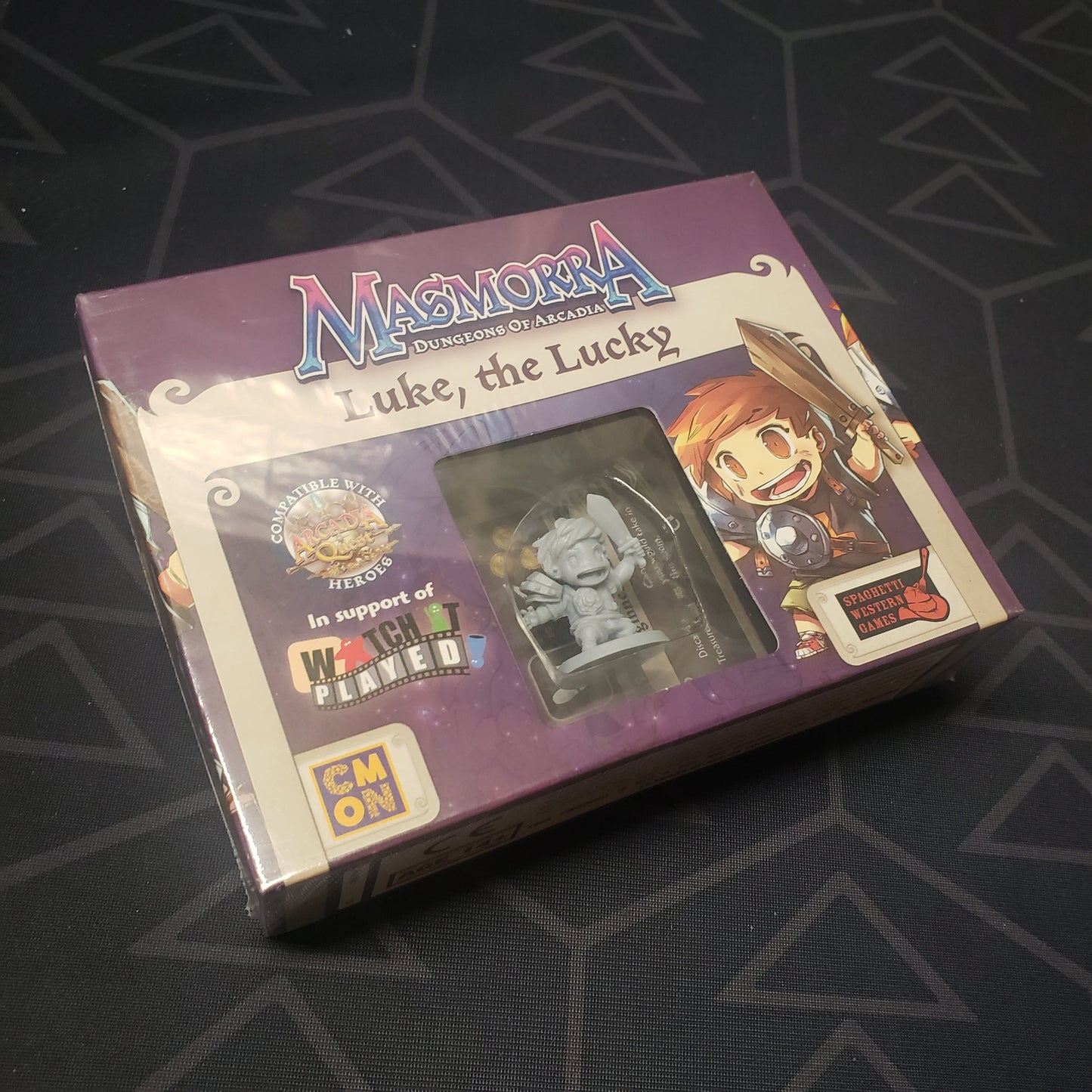 Image shows the front cover of the box of the Luke the Lucky expansion for the board game Masmorra: Dungeons of Arcadia