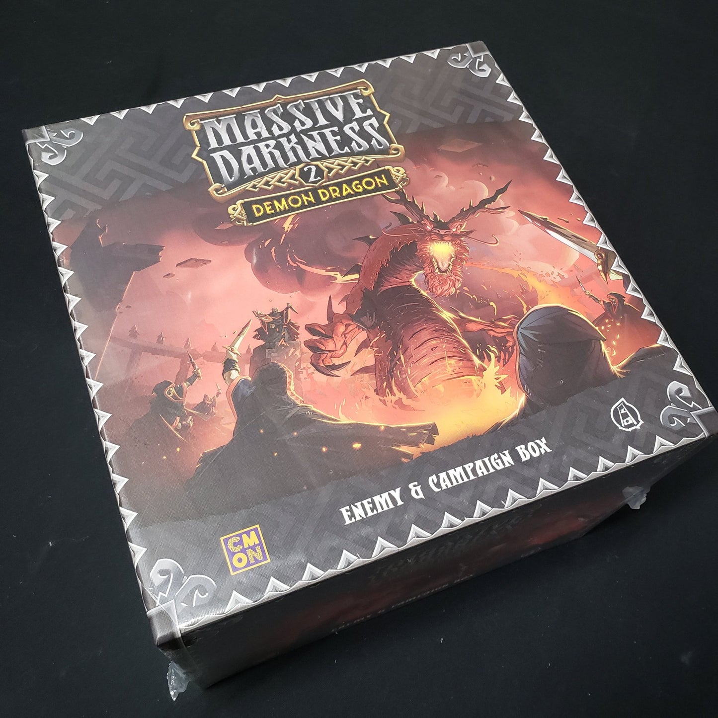 Image shows the front cover of the box of the Demon Dragon expansion for the board game Massive Darkness 2: Hellscape