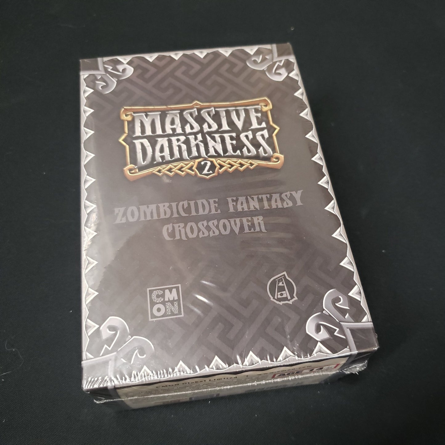 Image shows the front cover of the box of the Zombicide Fantasy Crossover expansion for the board game Massive Darkness 2: Hellscape