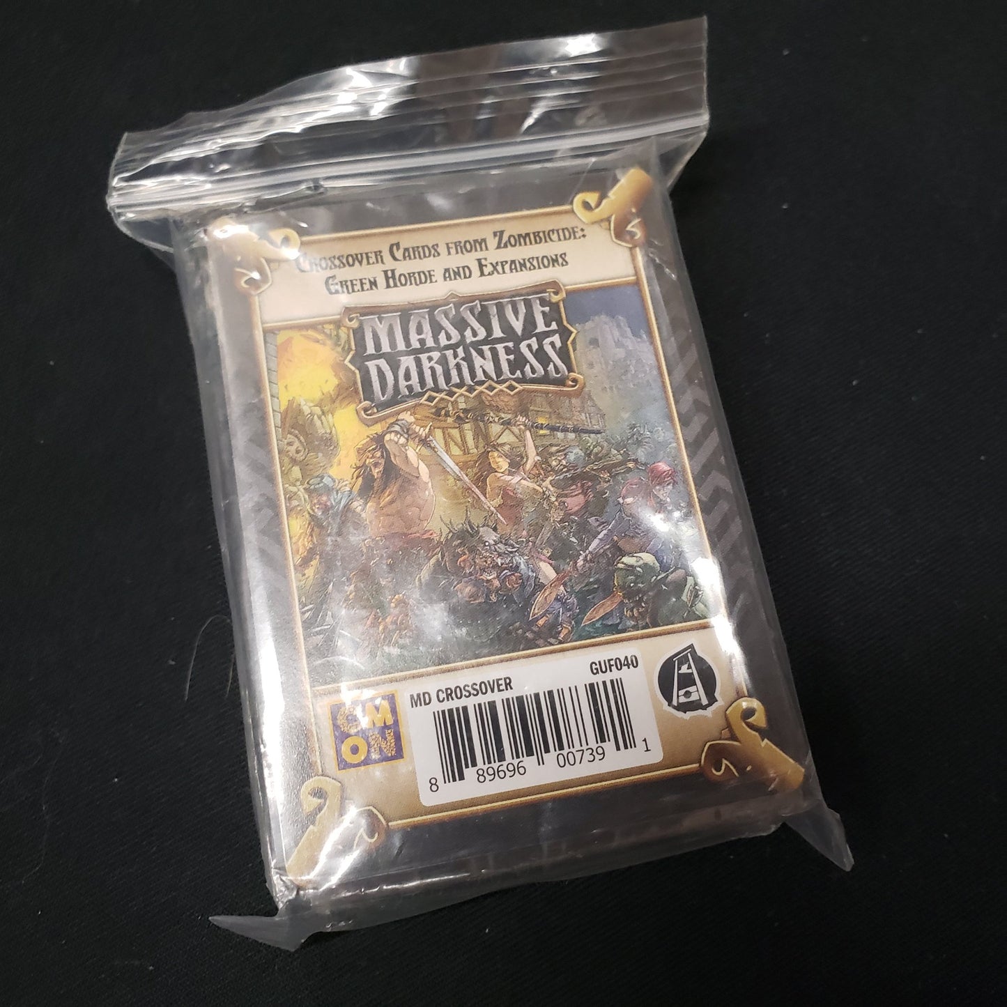 Image shows baggie with sealed cards inside from the Zombicide: Green Horde Crossover expansion for the board game Massive Darkness