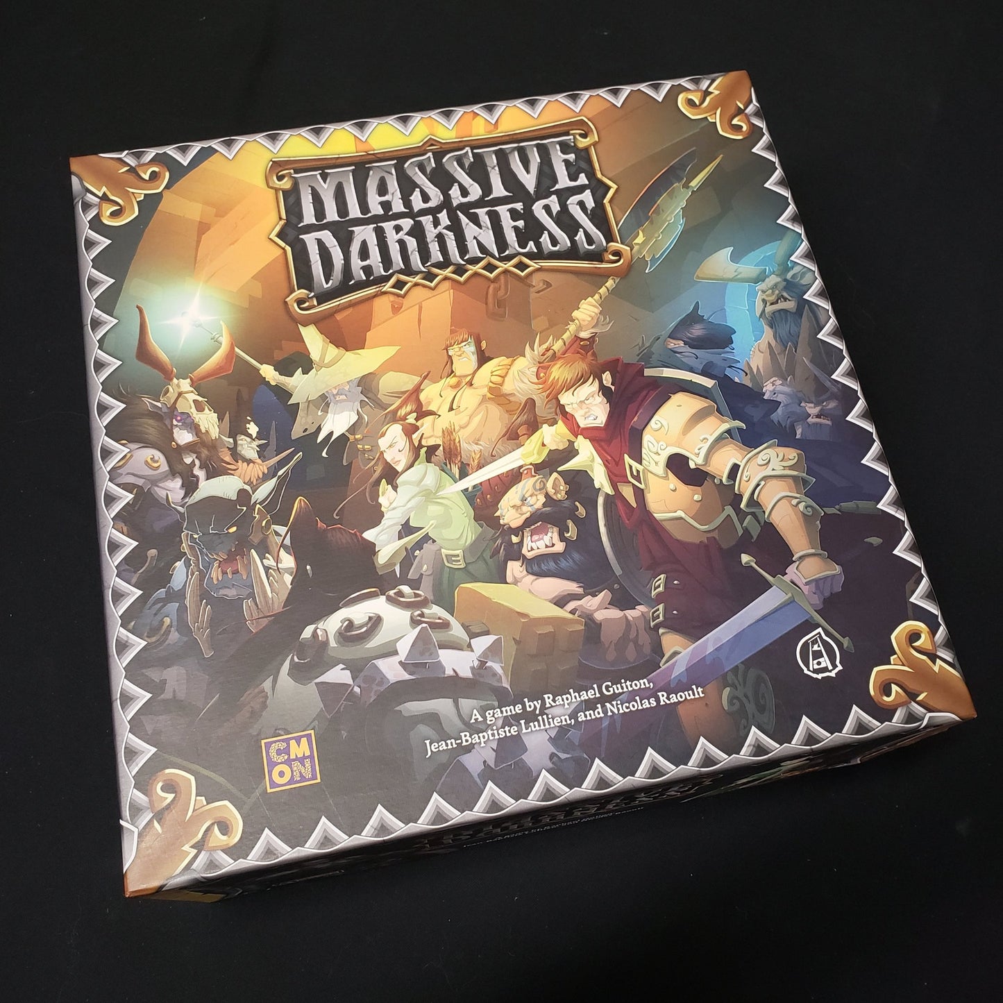 Image shows the front cover of the box of the Massive Darkness board game