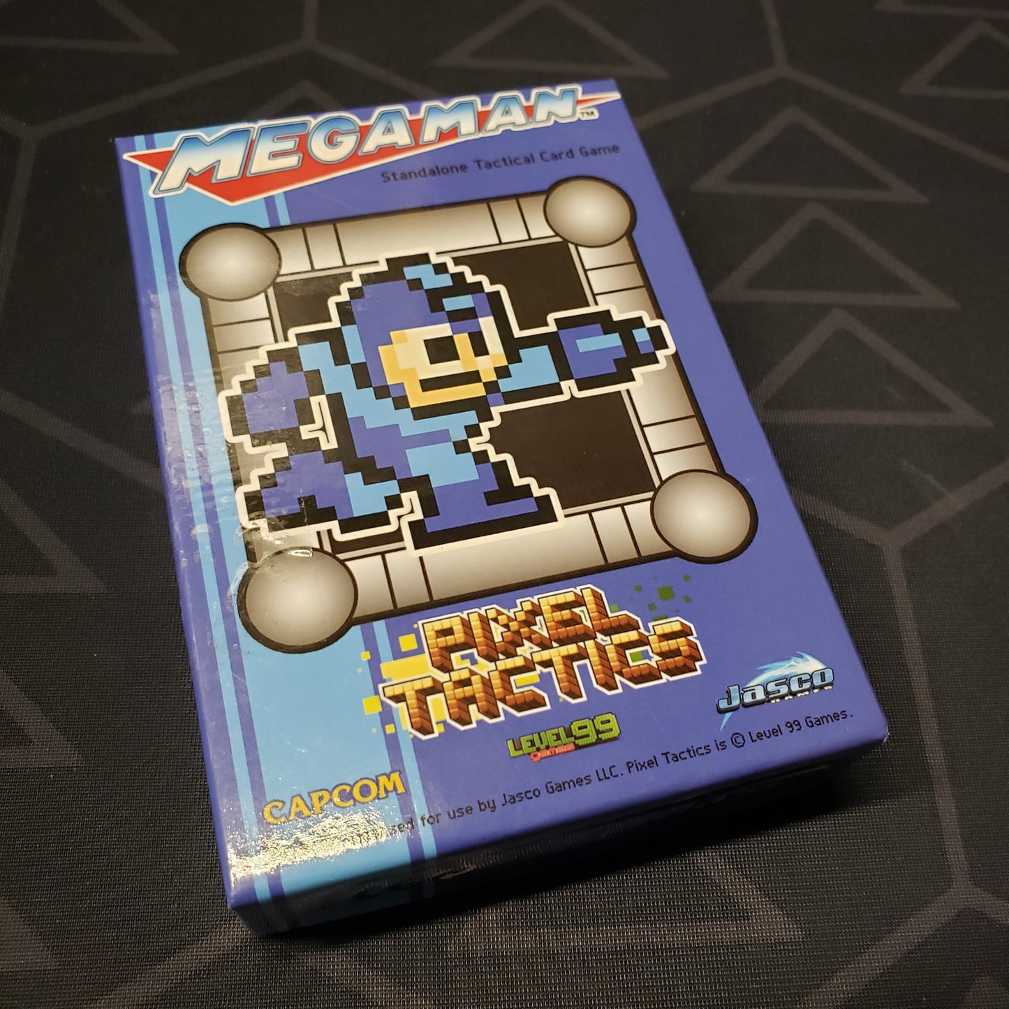 Image shows the front cover of the box for the Mega Man Pixel Tactics: Blue card game