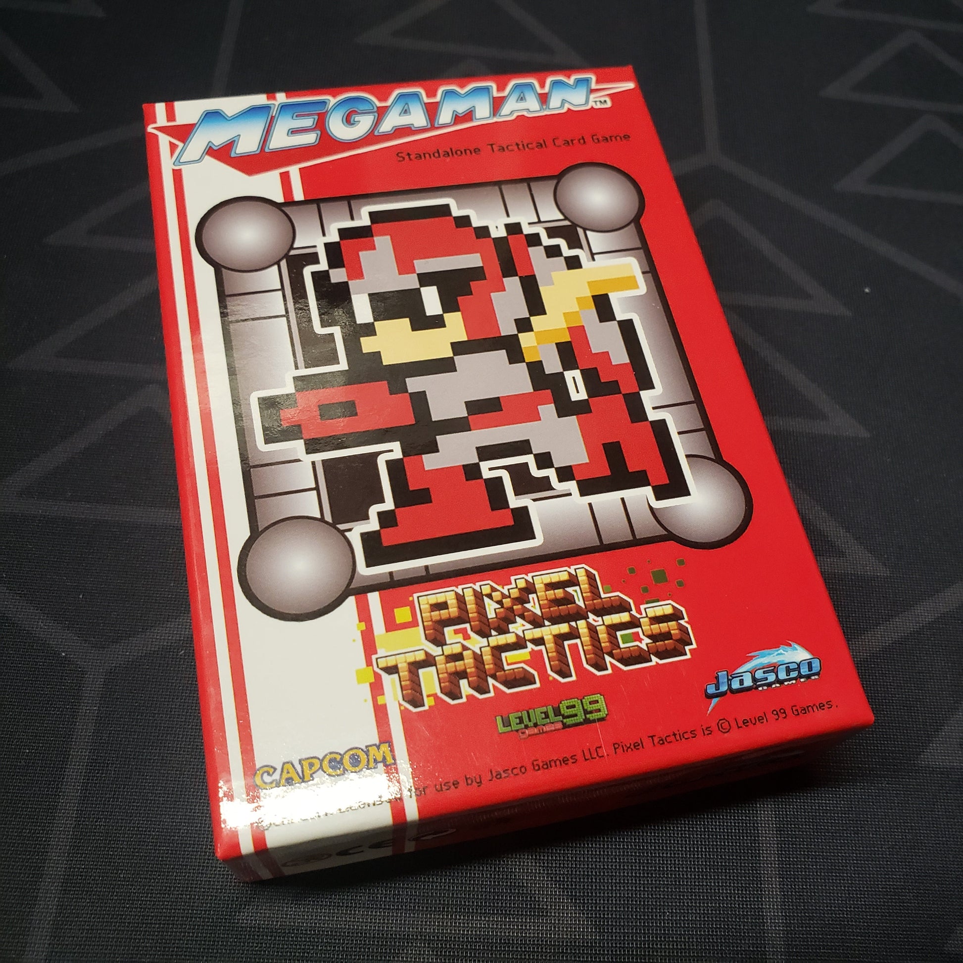 Image shows the front cover of the box for the Mega Man Pixel Tactics: Proto Man Red card game
