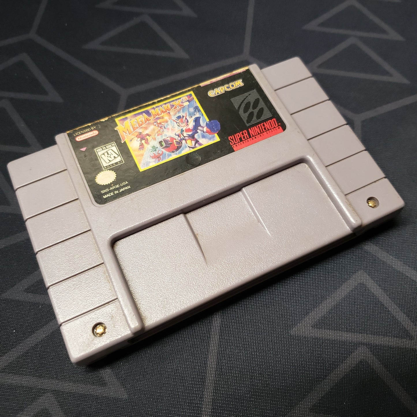 Image shows the front of the cartridge for the video game Mega Man X3 for Super Nintendo
