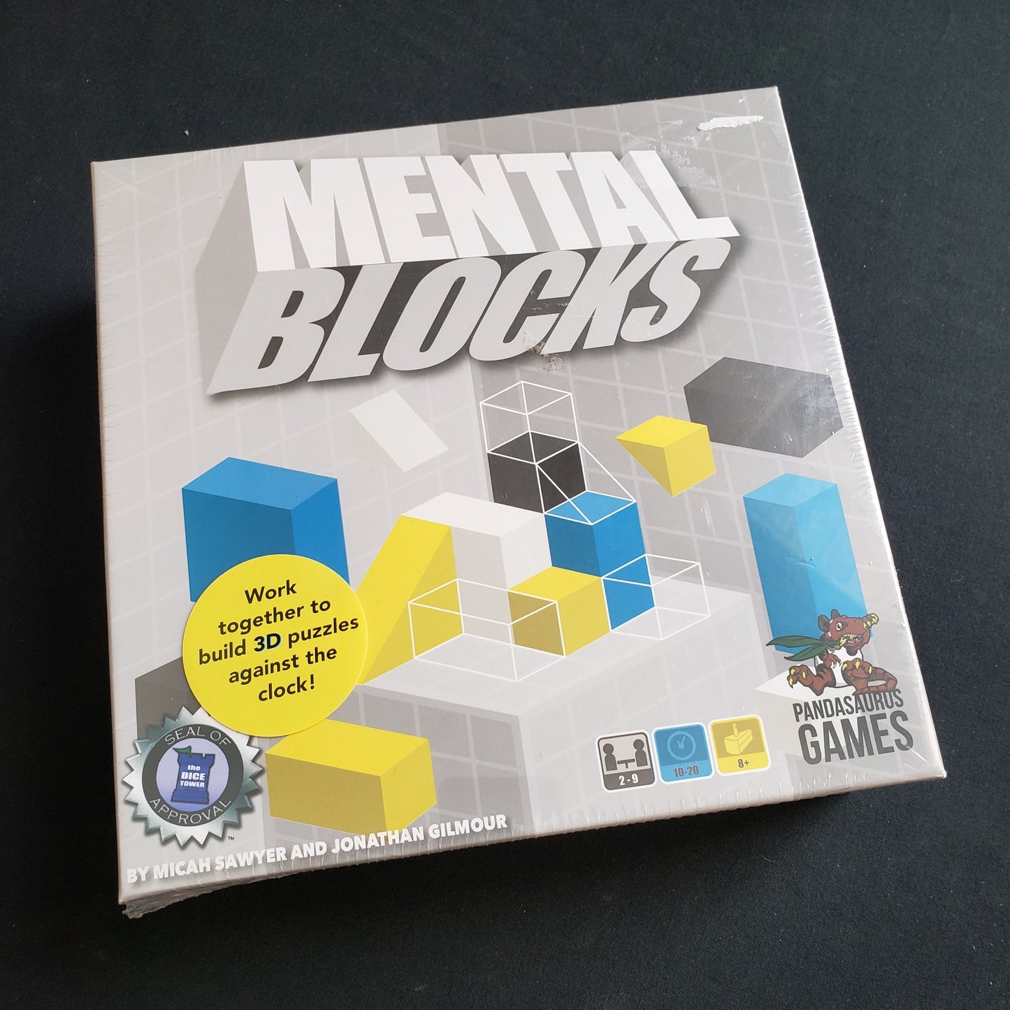 Image shows the front cover of the box of the Mental Blocks board game