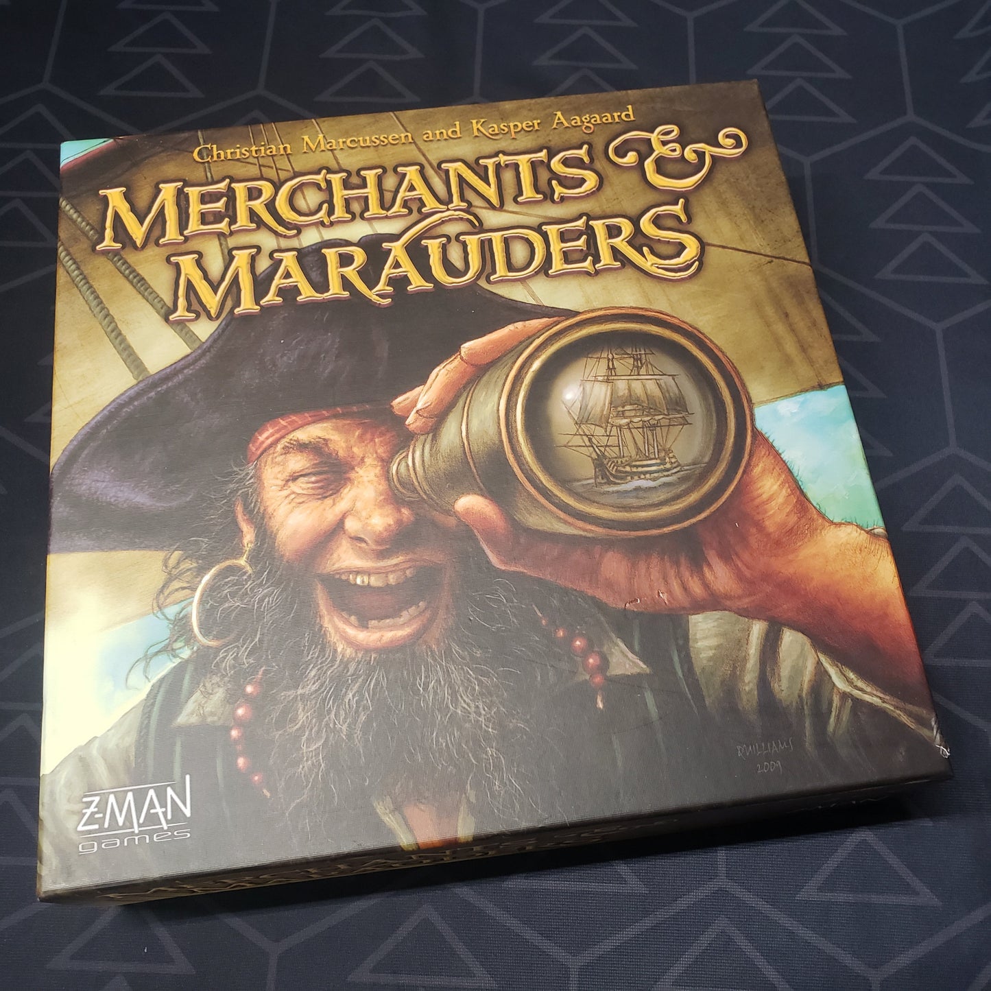 Image shows the front cover of the box for the Merchants & Marauders board game