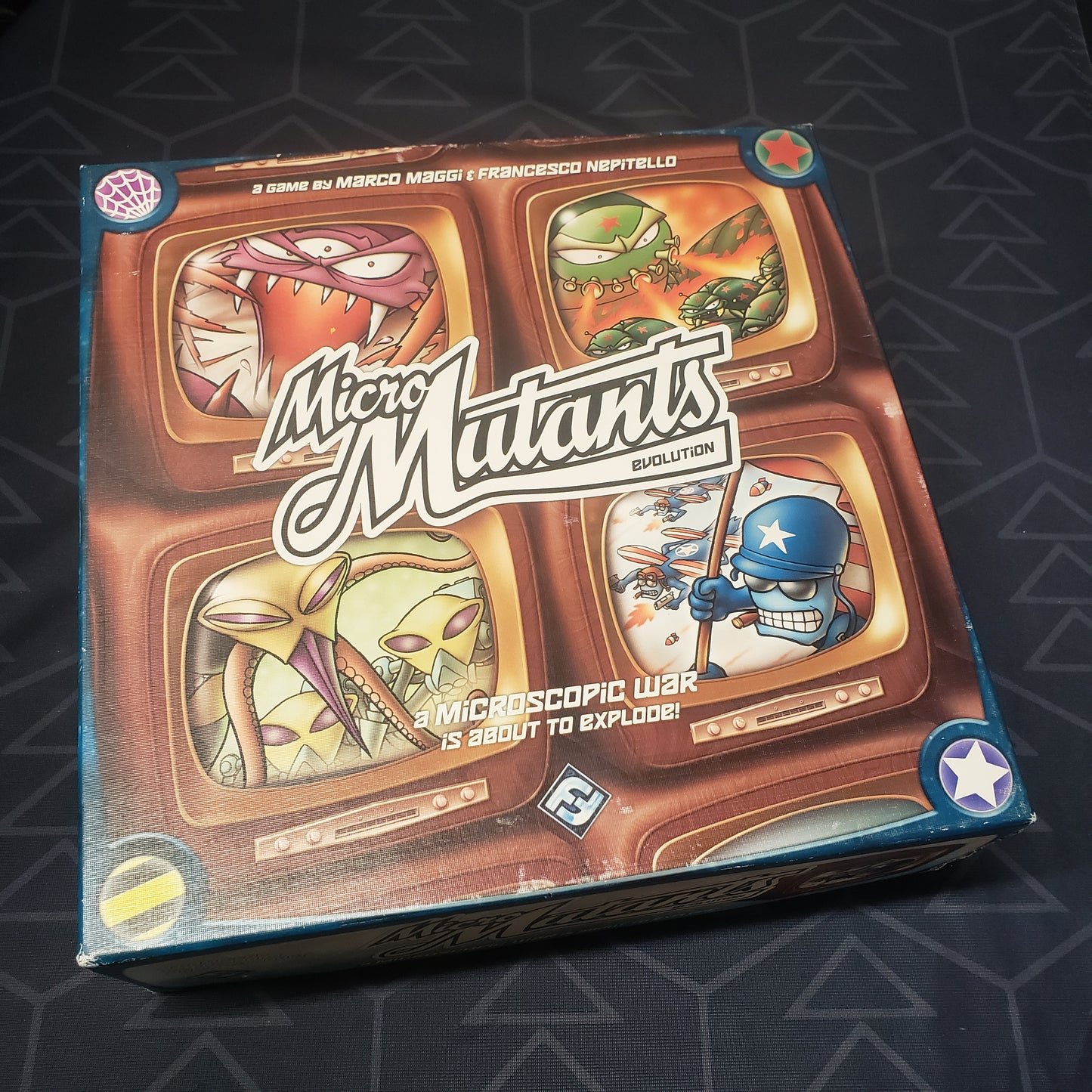 Image shows the front cover of the box of the Micro Mutants: Evolution board game
