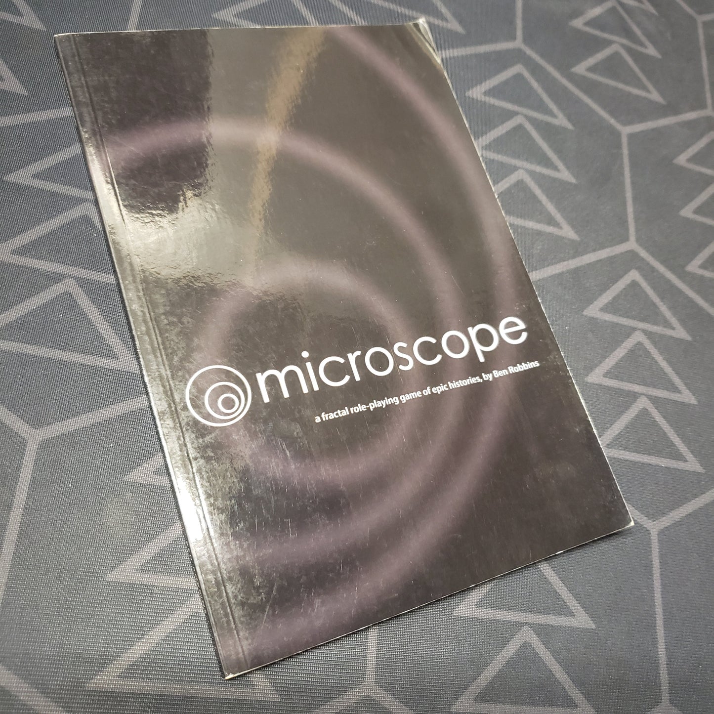 Image shows the front cover of the Microscope roleplaying game book