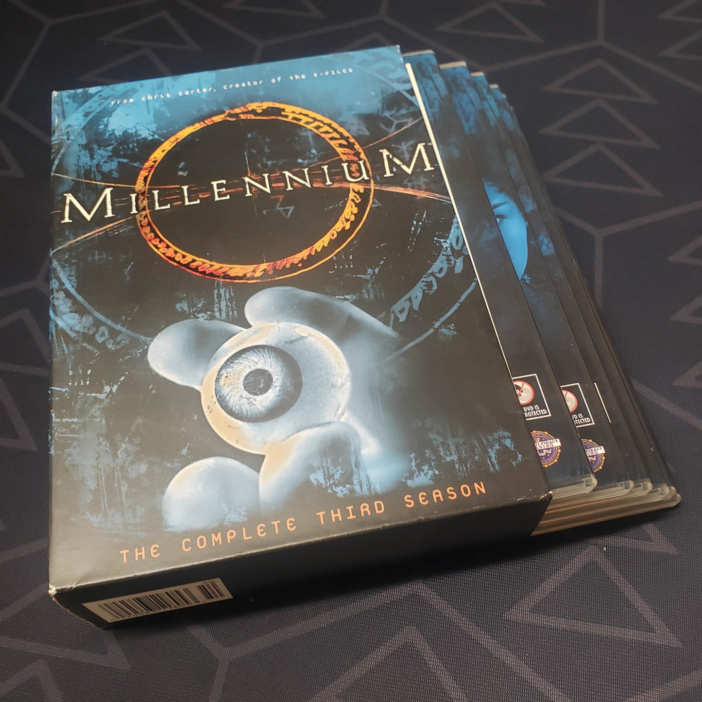 Image shows the outer box with the disc cases fanned out for Millennium: Season 3 on DVD