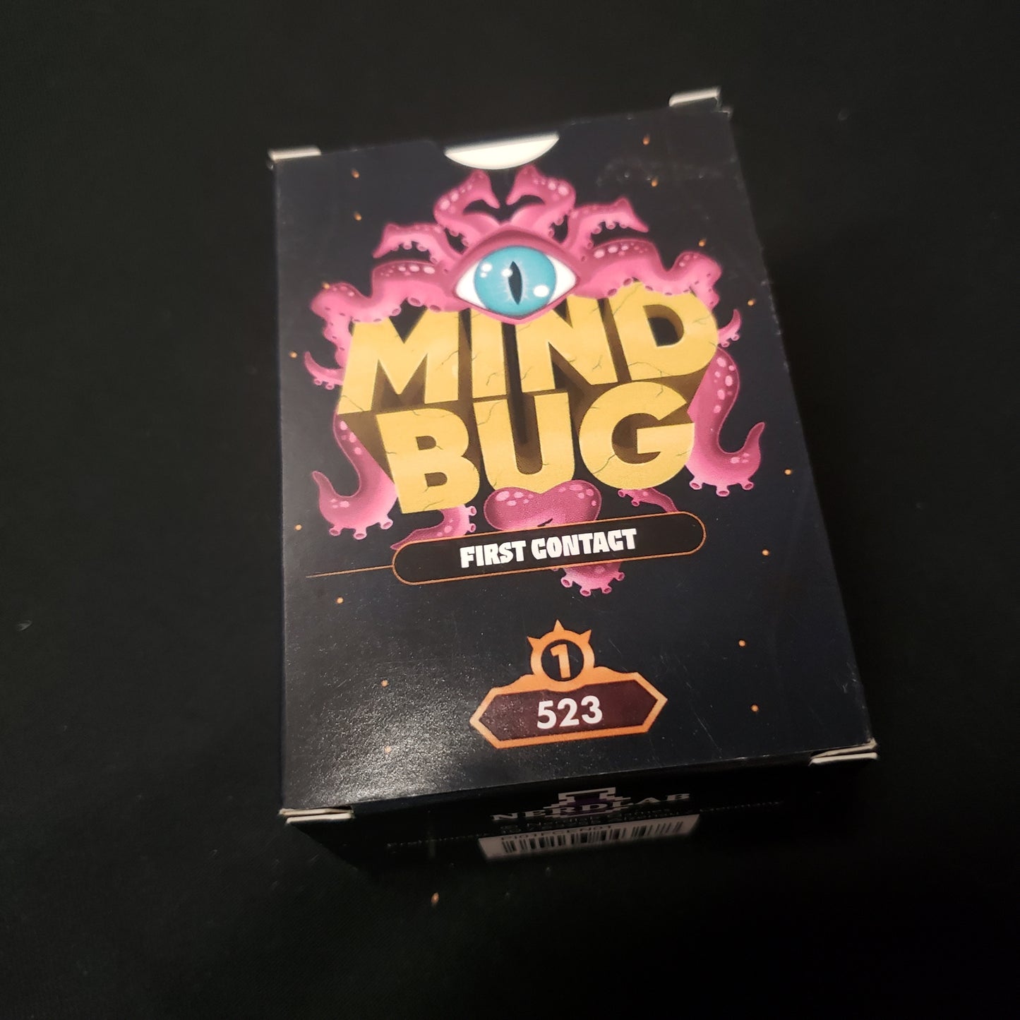 Image shows the front cover of the box of the Mindbug: First Contact card game