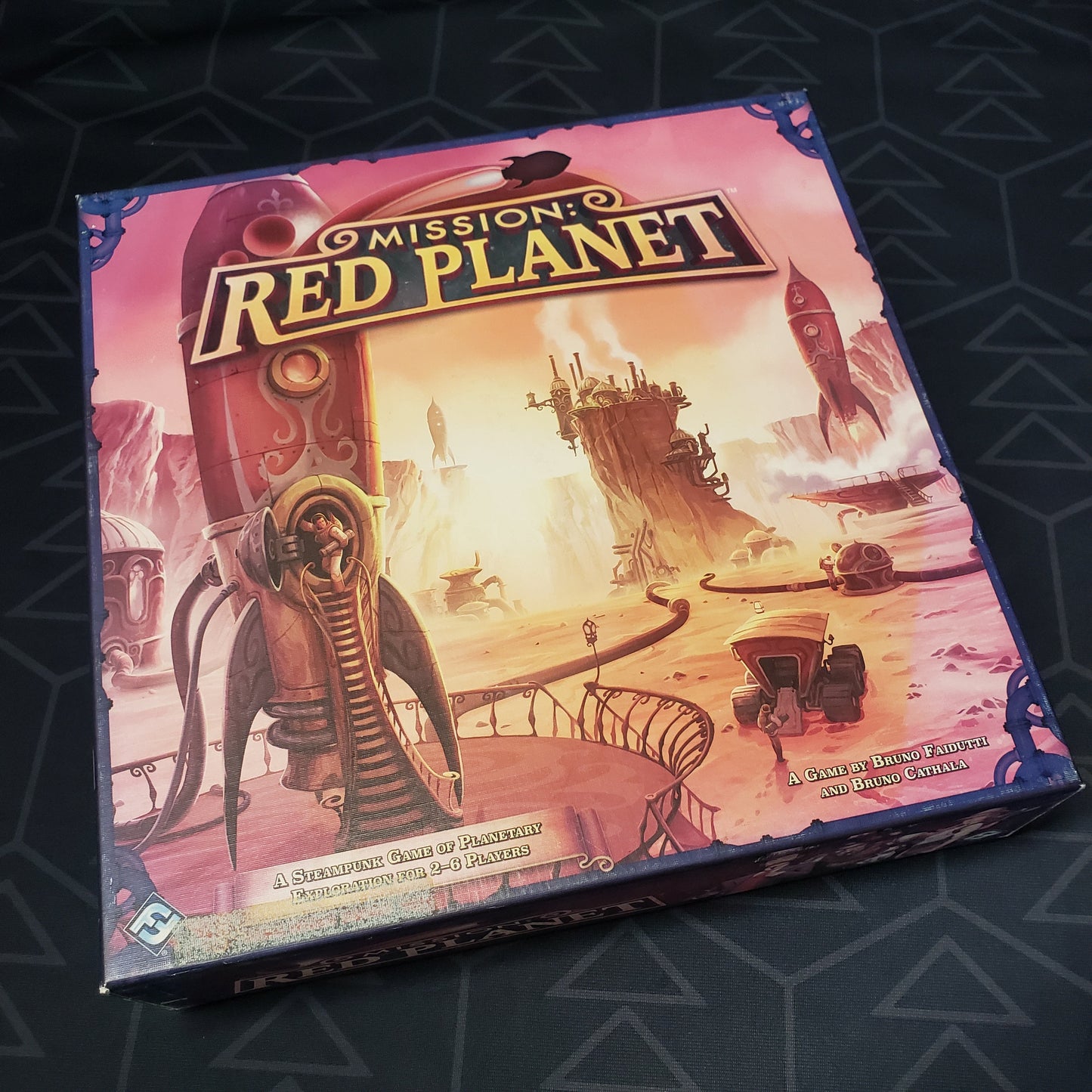 Image shows the front cover of the box of the Mission Red Planet board game