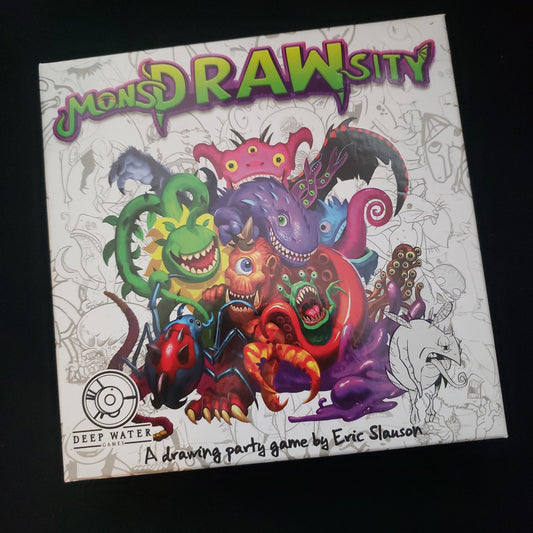 Image shows the front cover of the box of the MonsDRAWsity board game