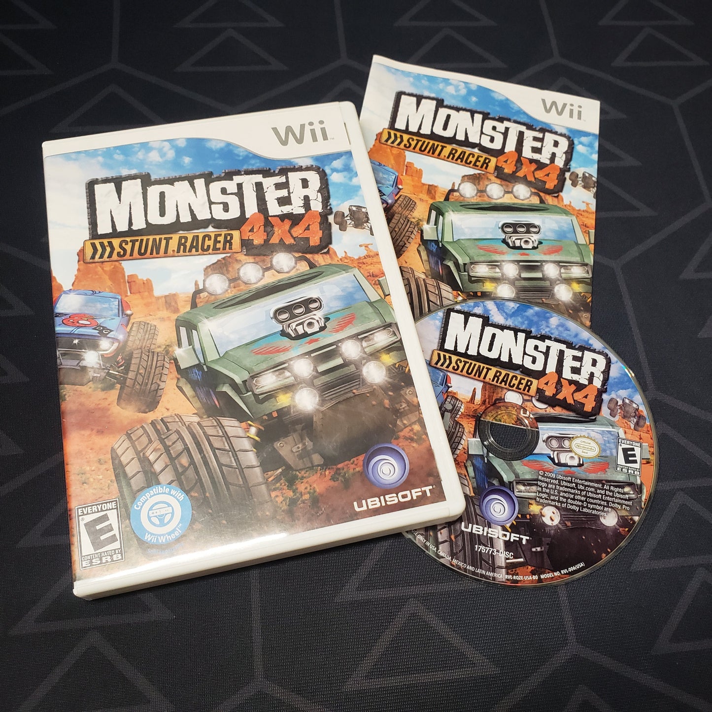 Image shows the case, manual and disc for the video game Monster 4x4: Stunt Racer for Nintendo Wii