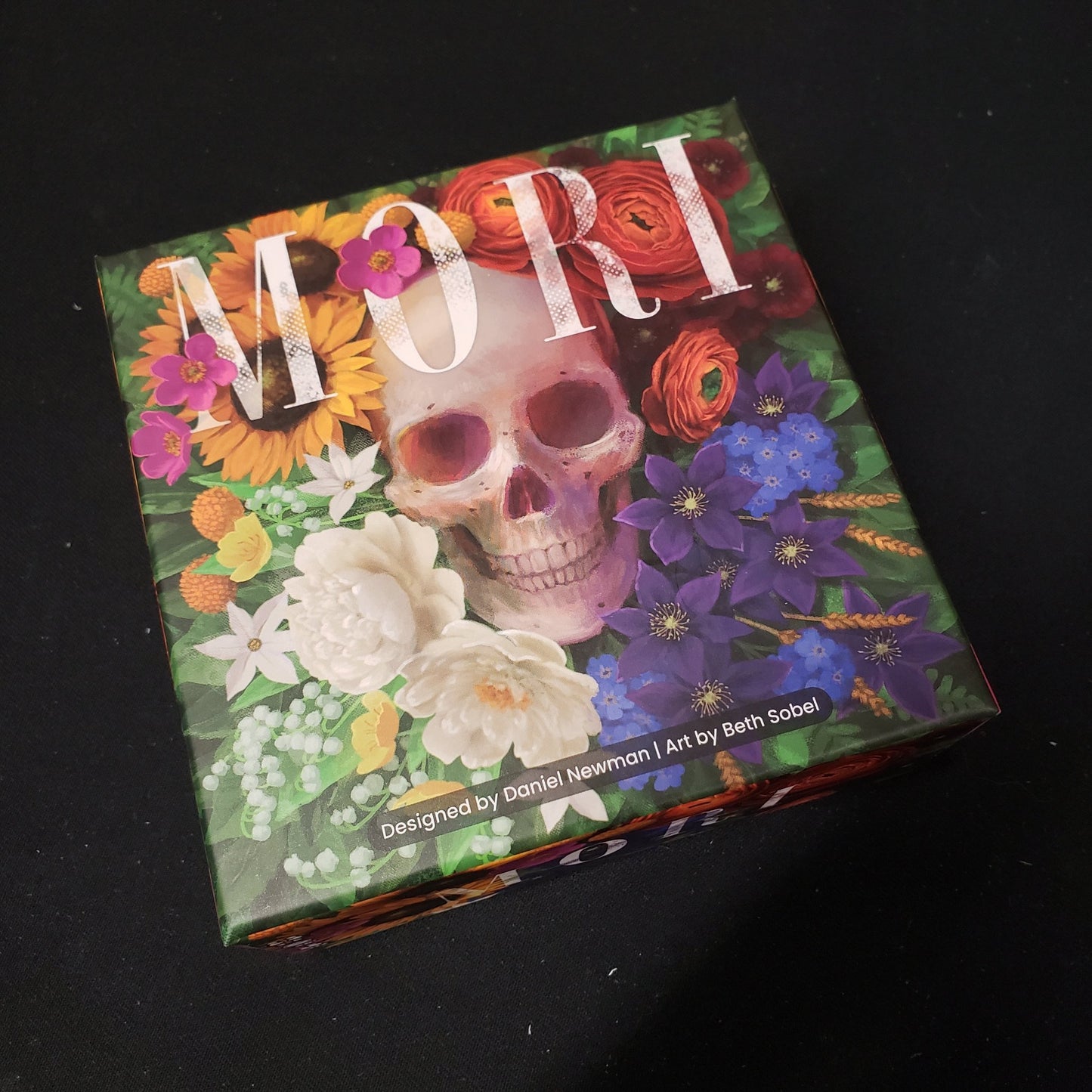 Image shows the front cover of the box of the Mori card game