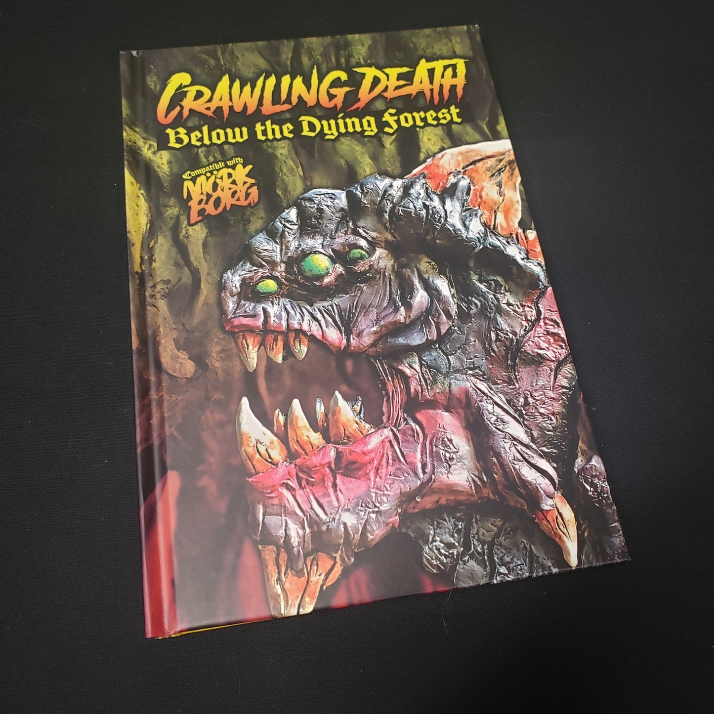 Image shows the front cover of the Crawling Death Below the Dying Forest roleplaying game book