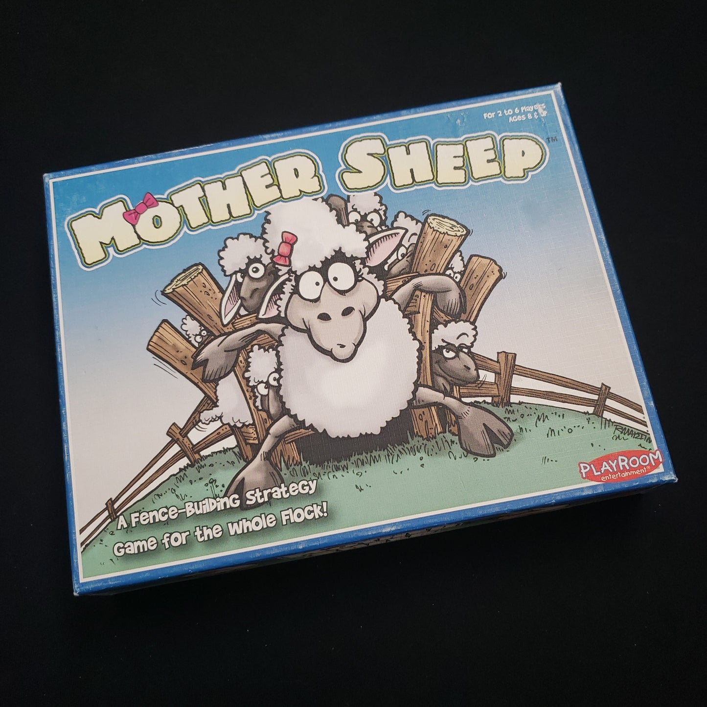 Image shows the front cover of the box of the Mother Sheep board game