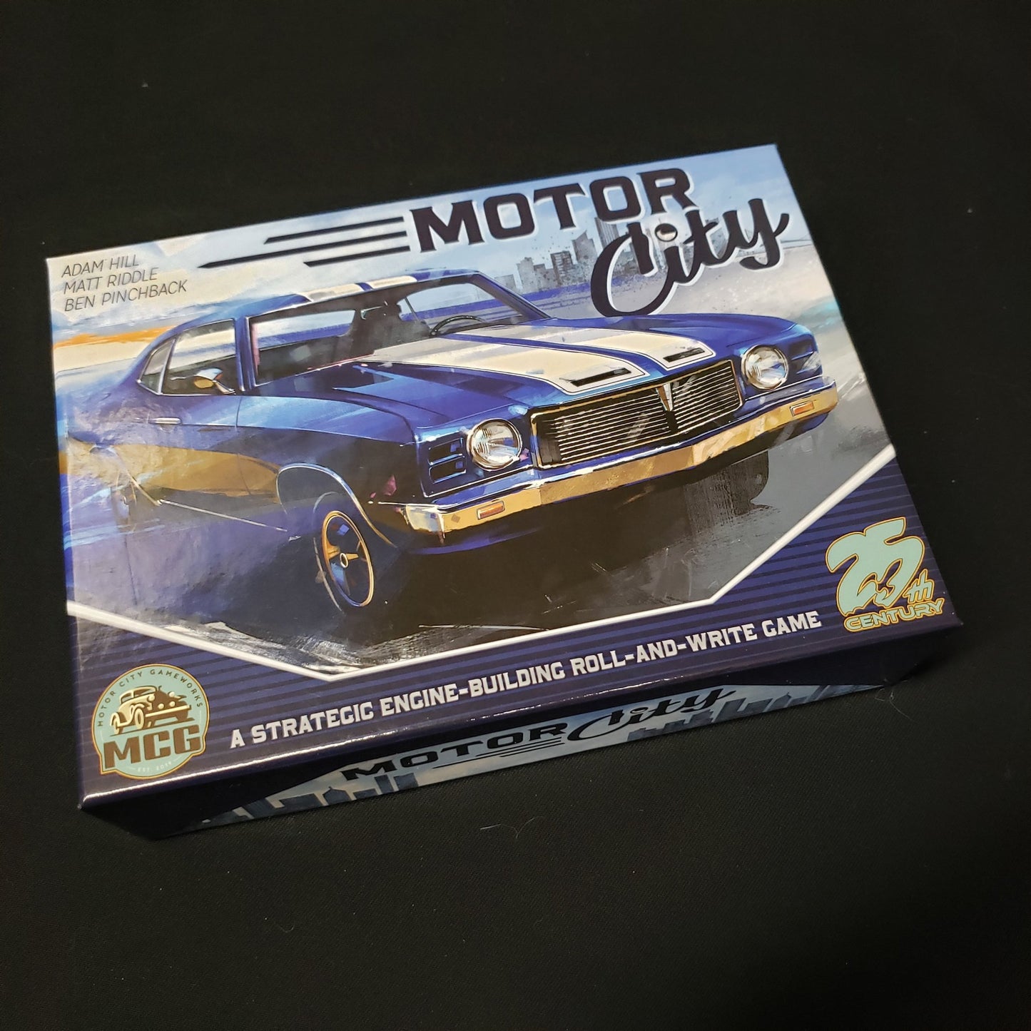 Image shows the front cover of the box of the Motor City board game