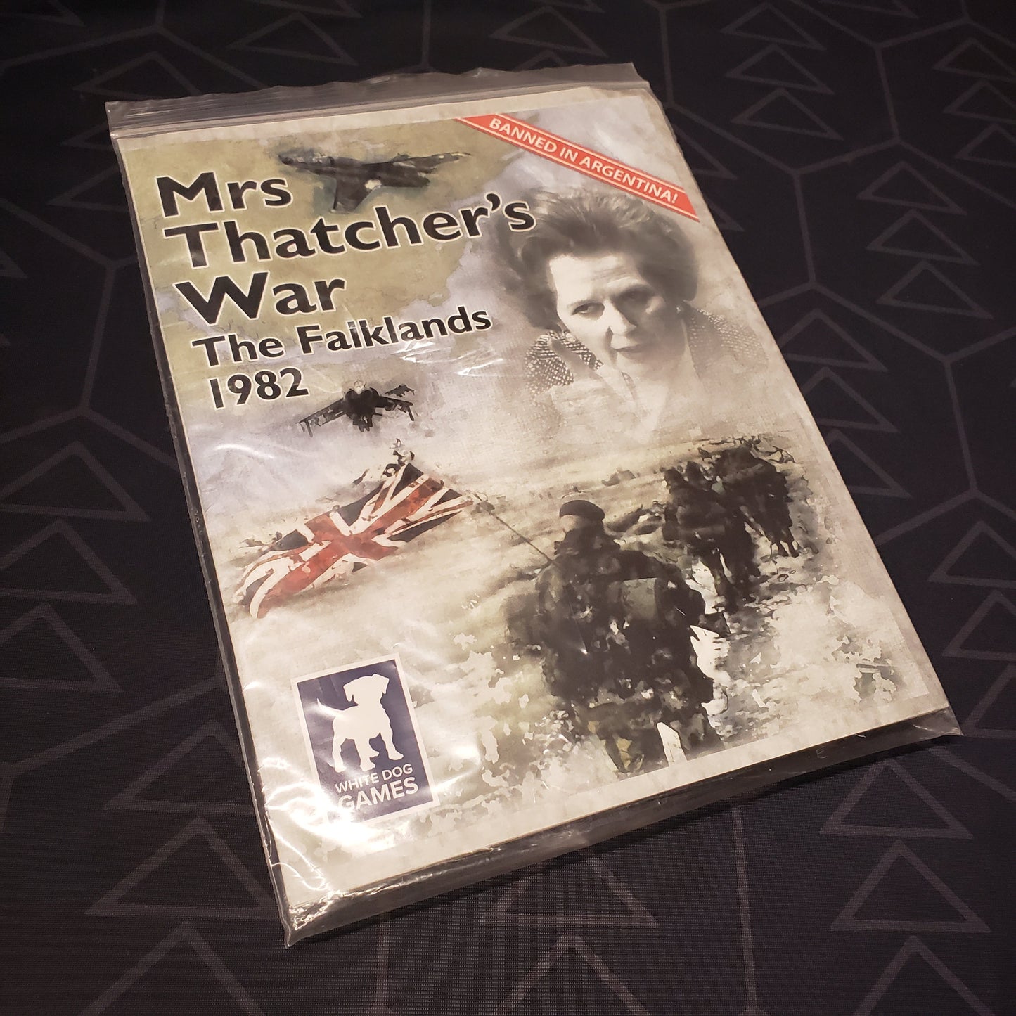 Image shows the front of the instructions for the Mrs. Thatcher's War: The Falklands, 1982 board game in its original plastic bag packaging