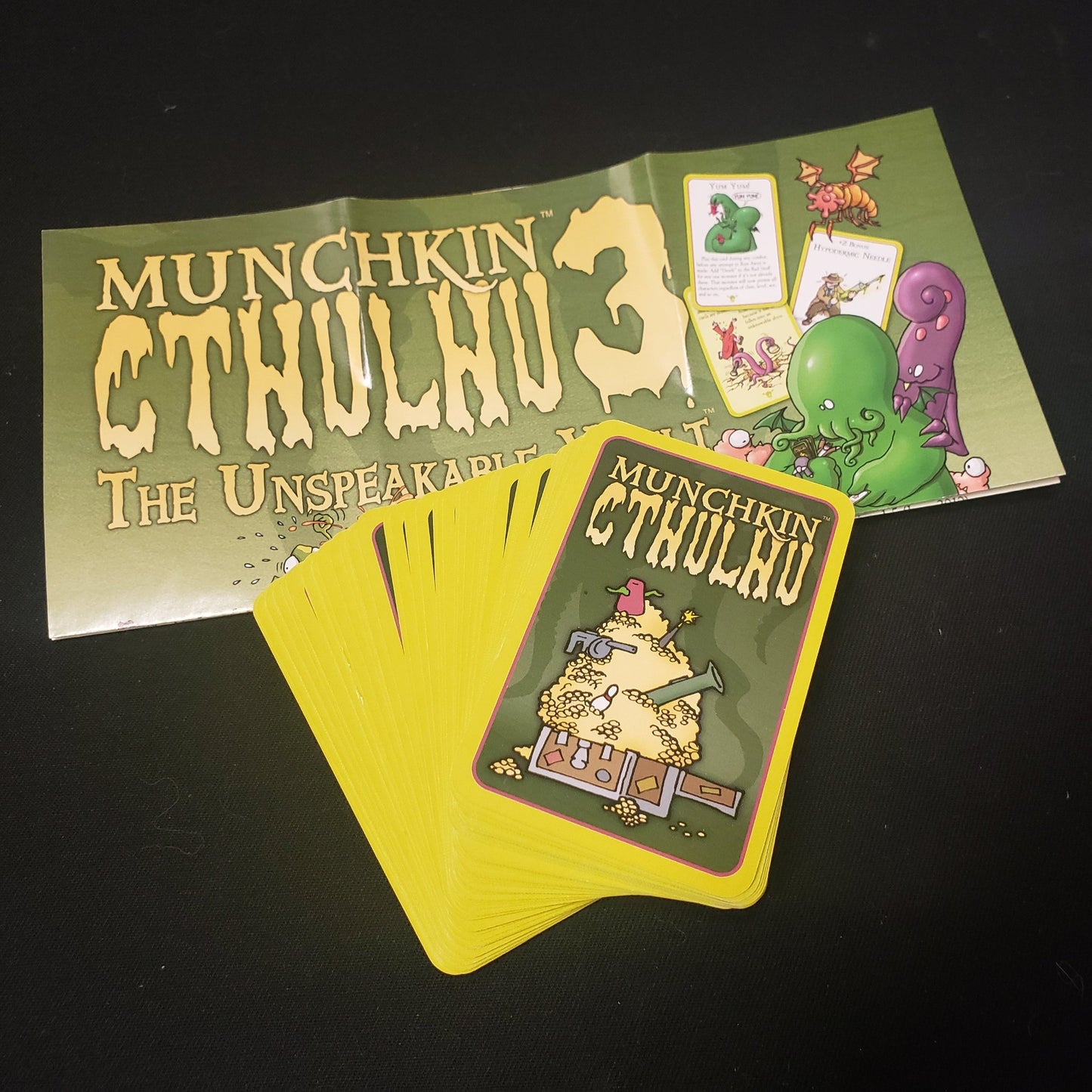 Image shows the instructions and cards for the Unspeakable Vault expansion for the card game Munchkin Cthulhu